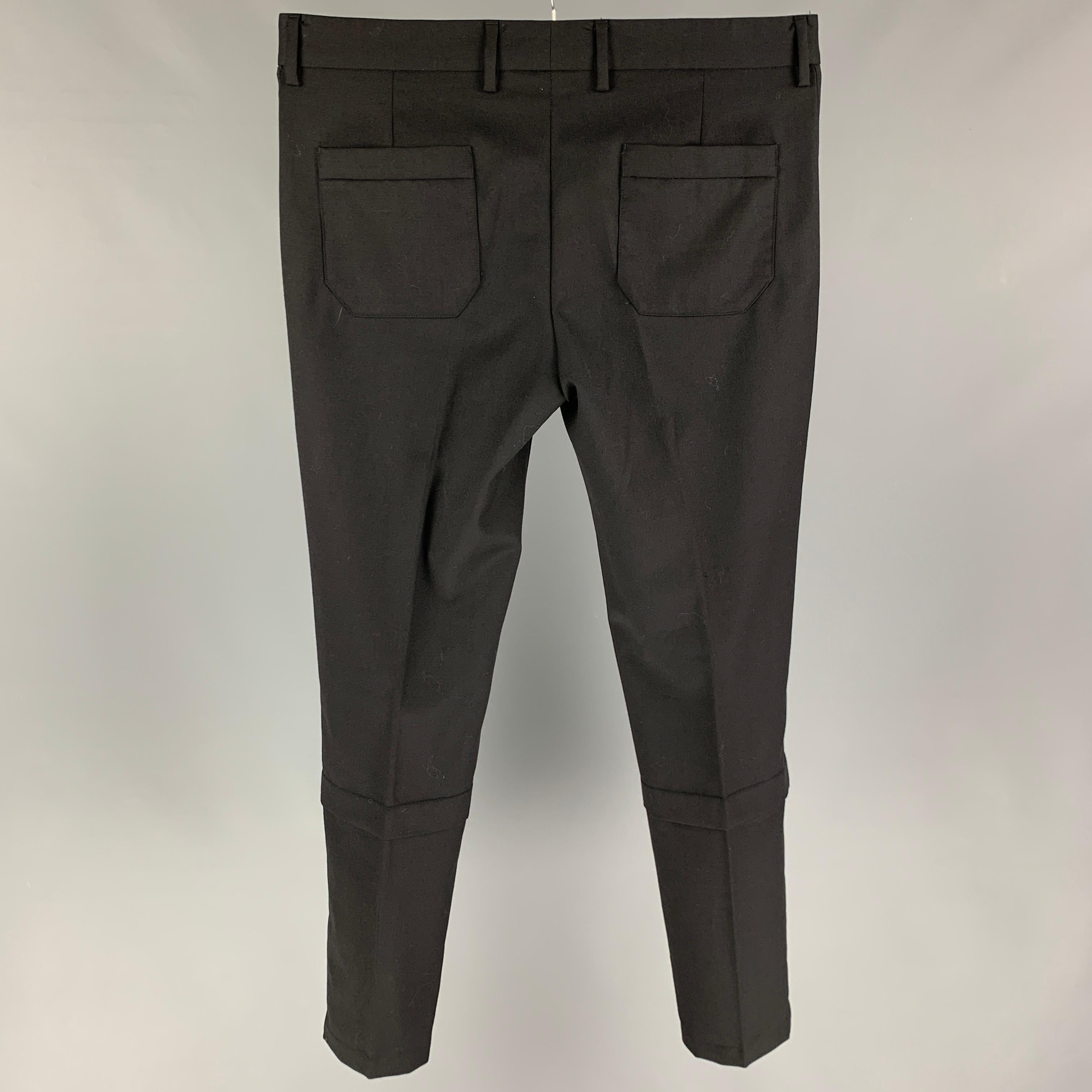 VIKTOR & ROLF pants comes in a black wool featuring a slim fit, front tab, and a zip fly closure. Made in Italy. 

Very Good Pre-Owned Condition.
Marked: 50

Measurements:

Waist: 34 in.
Rise: 9.5 in.
Inseam: 32 in. 