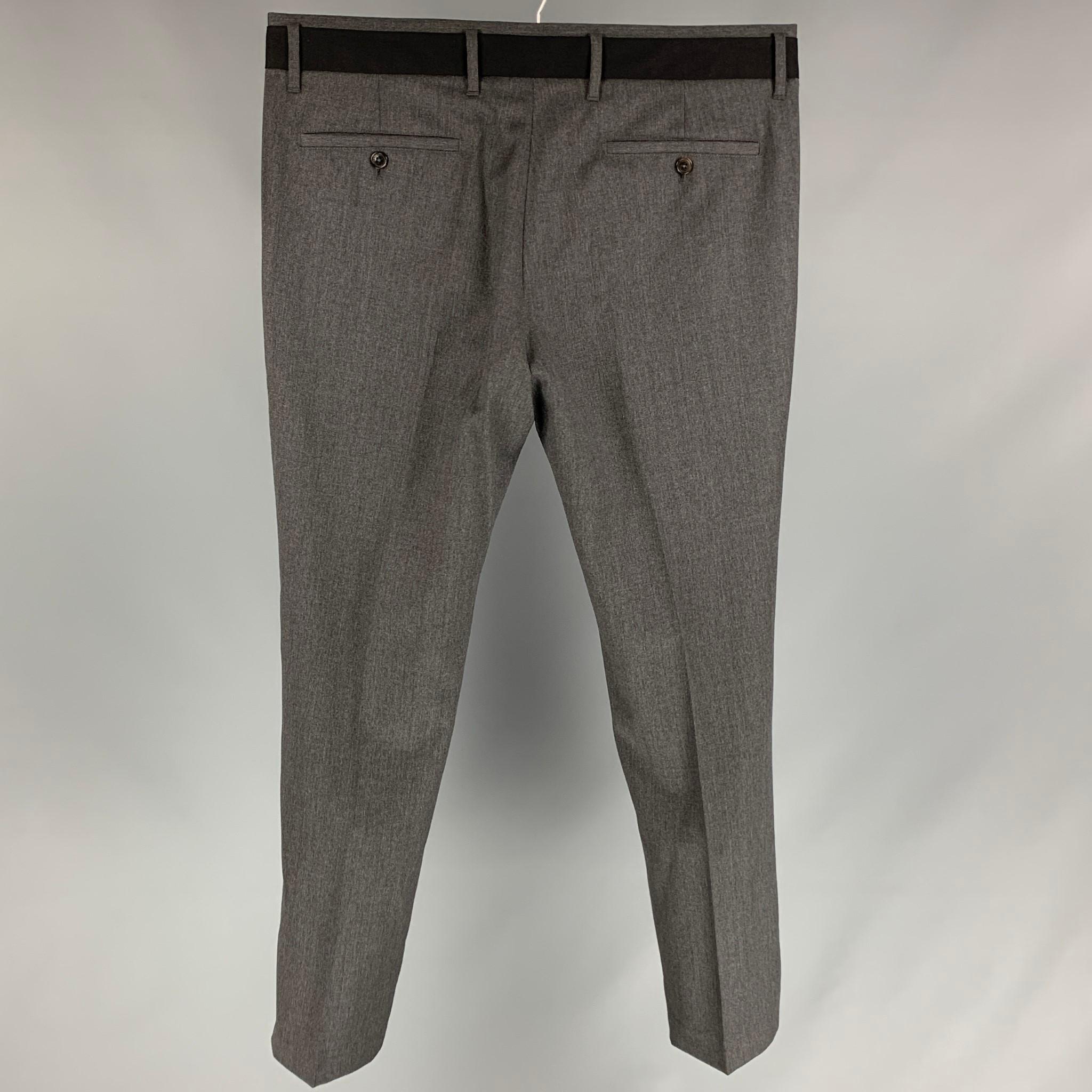 VIKTOR & ROLF tuxedo dress pants comes in a dark gray & black wool featuring a flat front, slim fit, front tab, and a zip fly closure. Made in Italy. 

Excellent Pre-Owned Condition.
Marked: 52

Measurements:

Waist: 36 in.
Rise: 9.5 in.
Inseam: 32