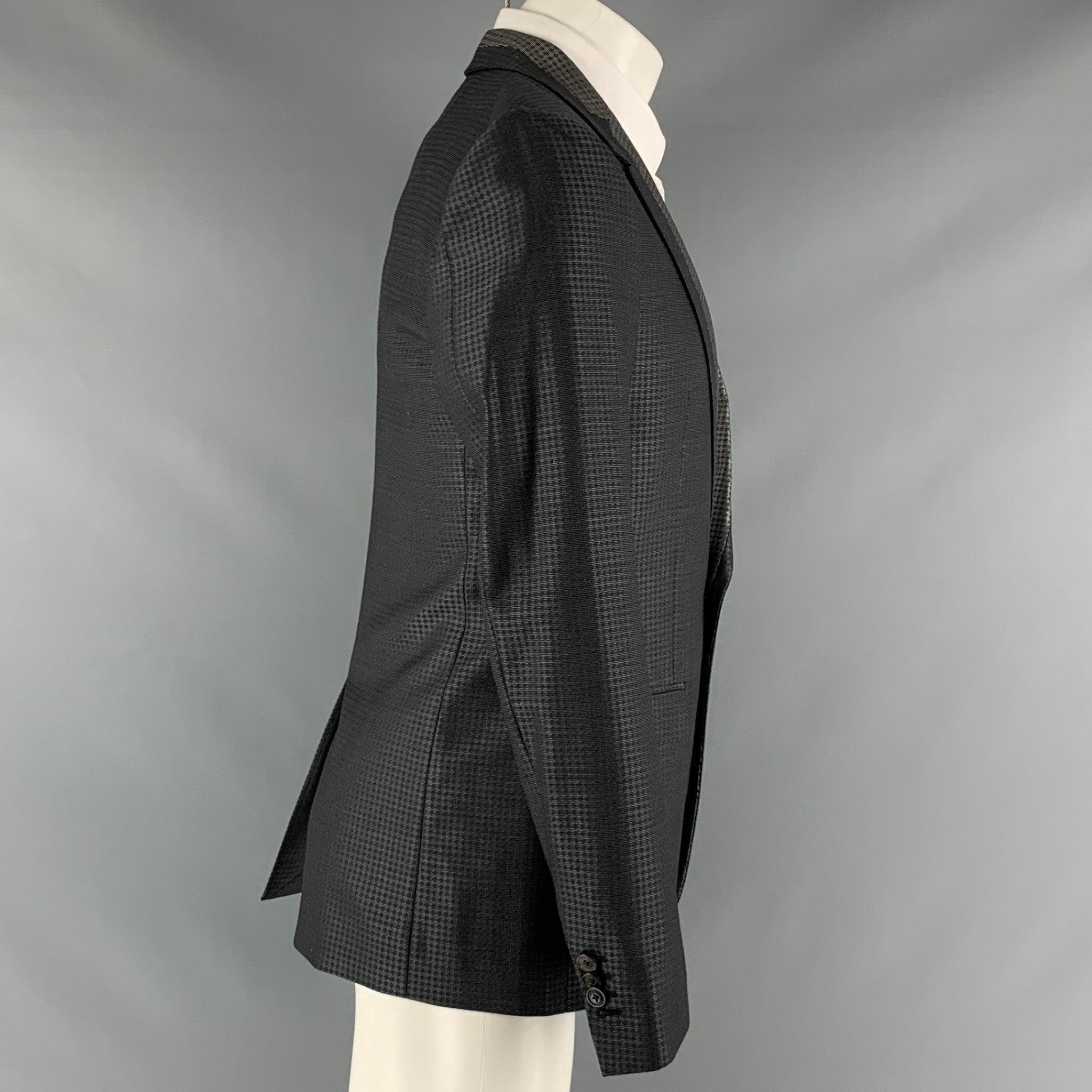 VIKTOR & ROLF sport coat comes in a black and grey plaid wool and silk jacquard material with a full liner featuring a notch lapel, flap pockets, single back vent, and a double button closure. Made in Italy. Excellent Pre-Owned Condition. 

Marked: 