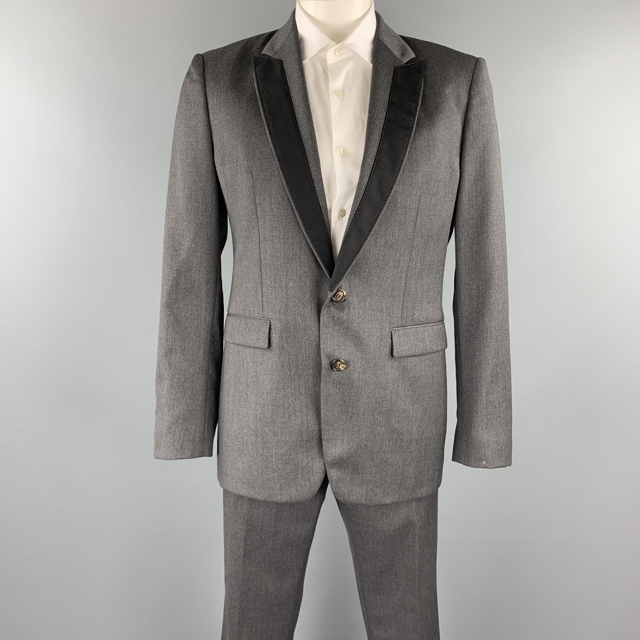 VIKTOR & ROLF suit comes in a dark gray wool and includes a single breasted, two button sport coat with a peak lapel, black trim detail, and matching front trousers. Made in Italy.

Excellent Pre-Owned Condition.
Marked: