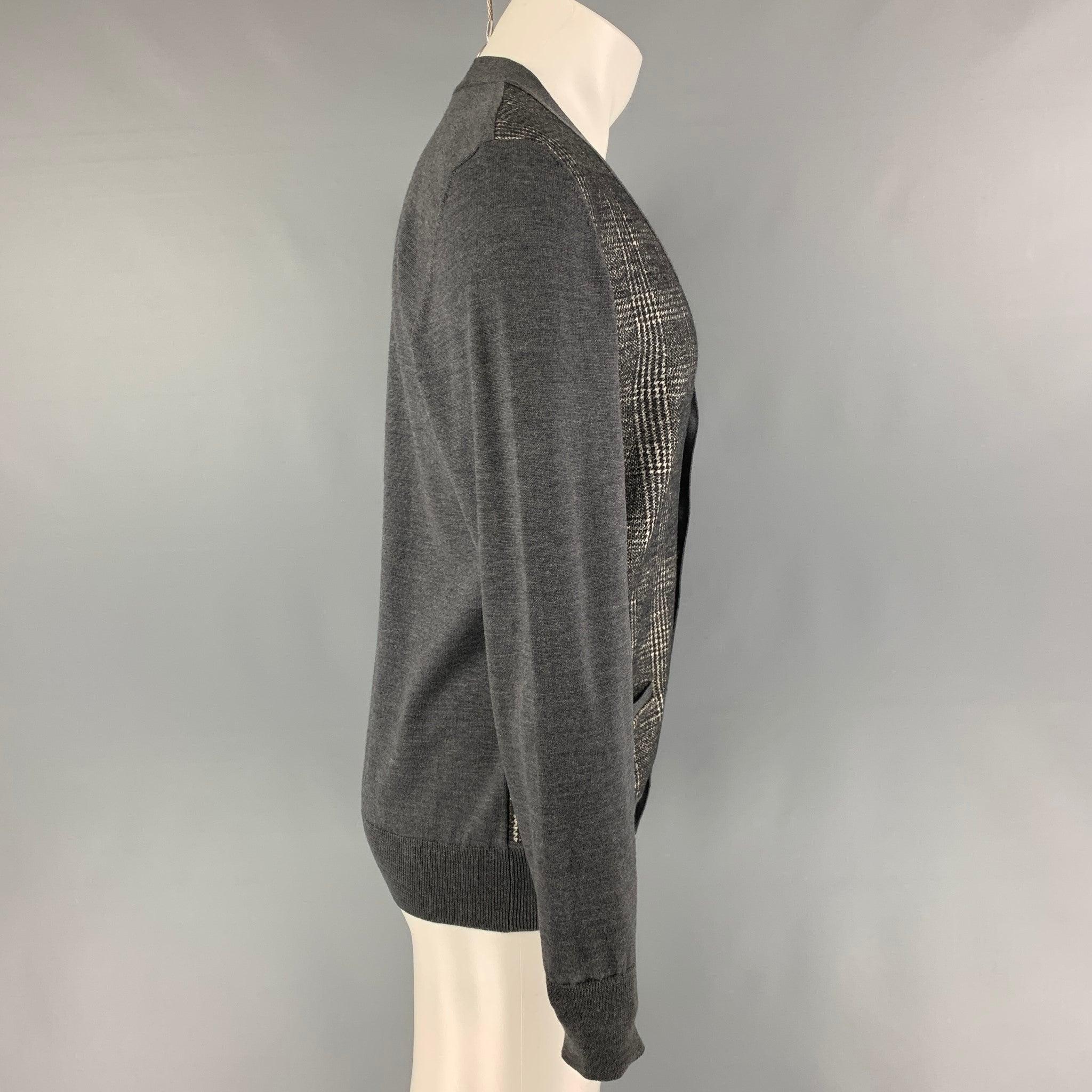 VIKTOR & ROLF cardigan comes in a grey & cream mixed print wool featuring front pockets and a buttoned closure. Made in Italy.
Very Good
Pre-Owned Condition. 

Marked:   M  

Measurements: 
 
Shoulder: 18 inches  Chest: 41 inches  Sleeve: 27 inches 