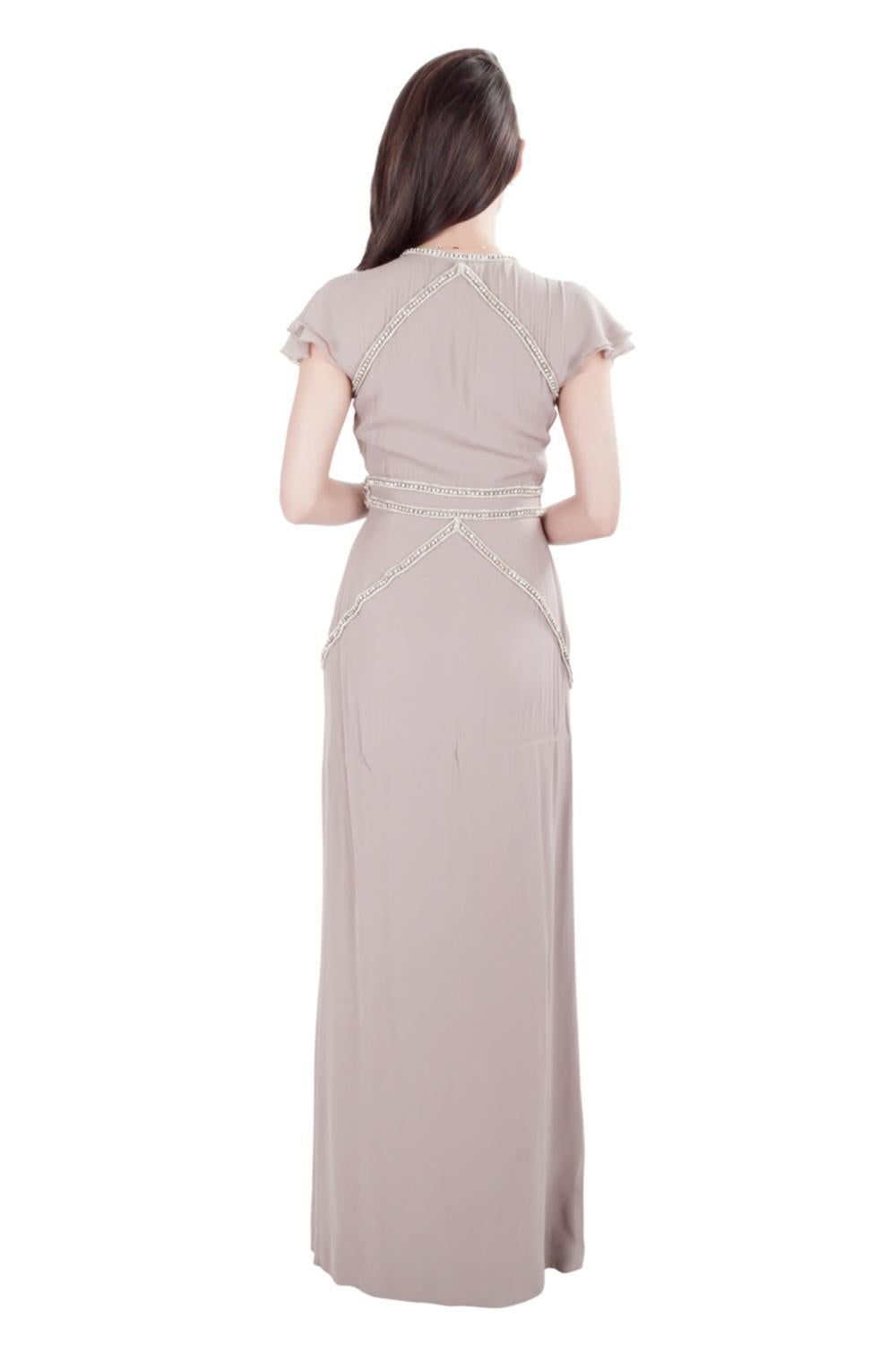 Viktor & Rolf design their elegant evening wears with subtle hints of glamor. This gown in an understated mauve shade features a plunging neckline and a flattering length. It is styled with short flutter sleeves and crystal embellishments at the