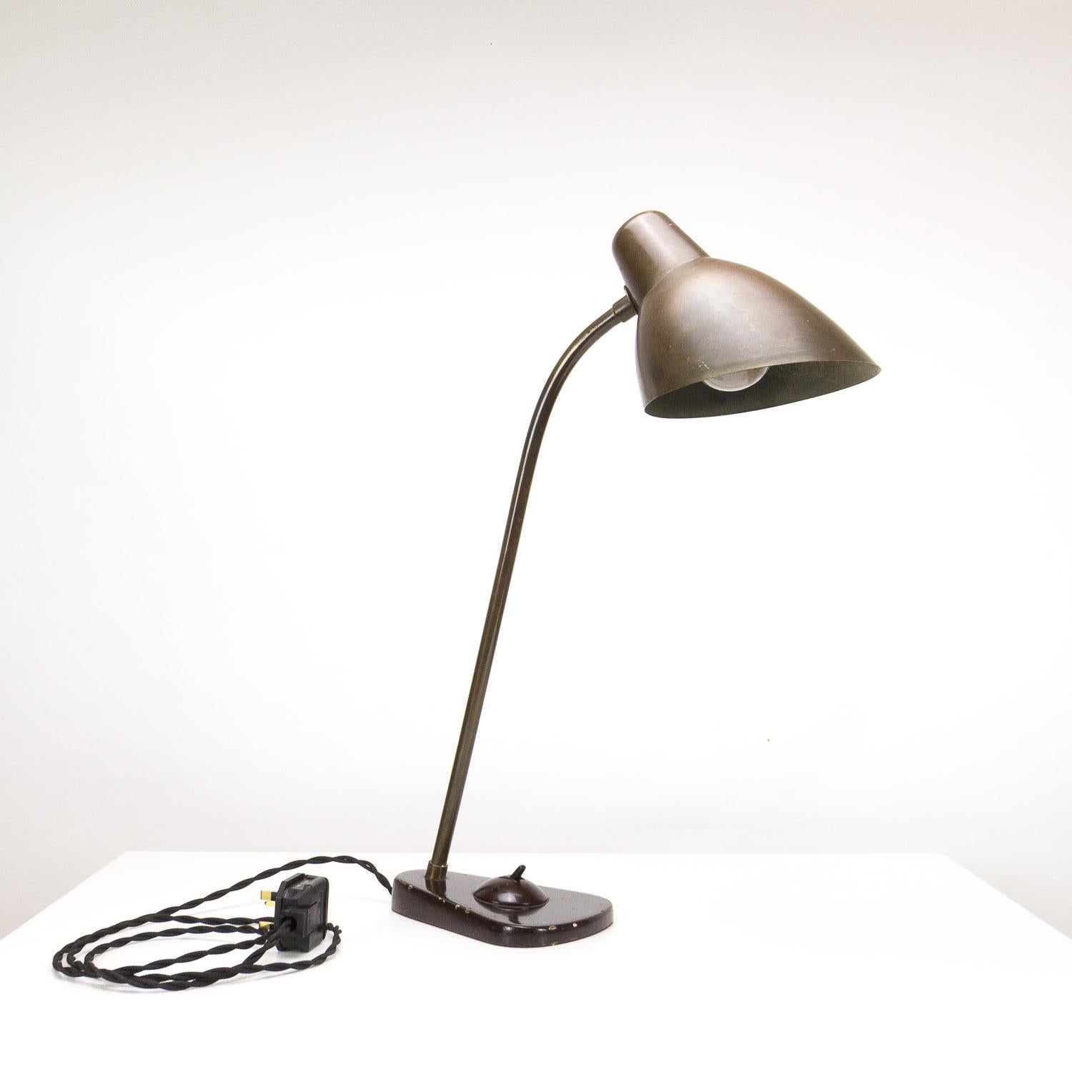 A rare Konduktørlampe designed by Vilhelm Lauritzen in Denmark, 1930s. Made for DSB by Louis Poulsen. Brass shade and stem, enamel coated cast iron base and Bakelite switch, all original. This light has elements of perfection in its design. The