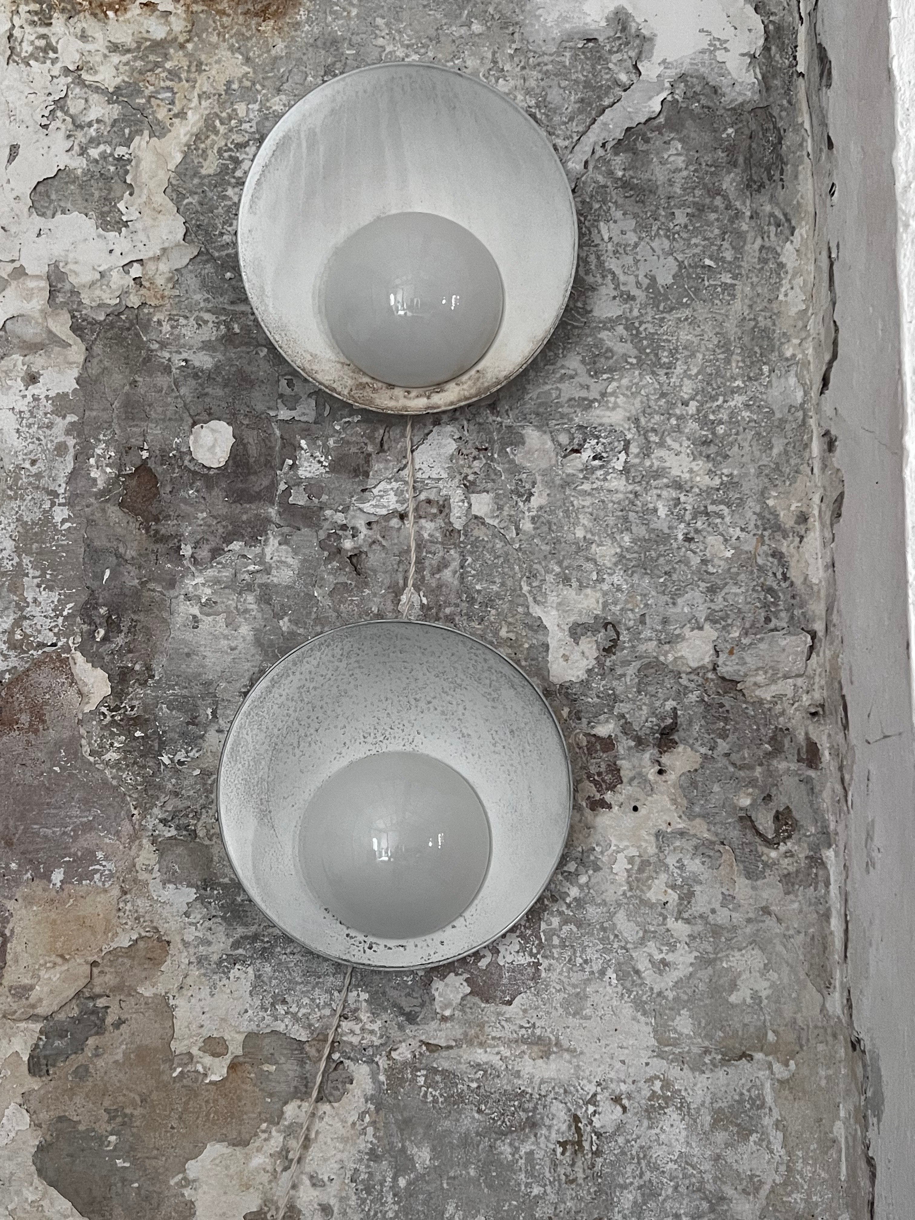 2 untouched and patinated trough time lamps by master Danish architect Vilhelm Lauritzen. The lamps were designed for the Kastrup airport in Copenhagen (1937-39) and produced by Louis Poulsen. Usually they are repainted white but these are keeping