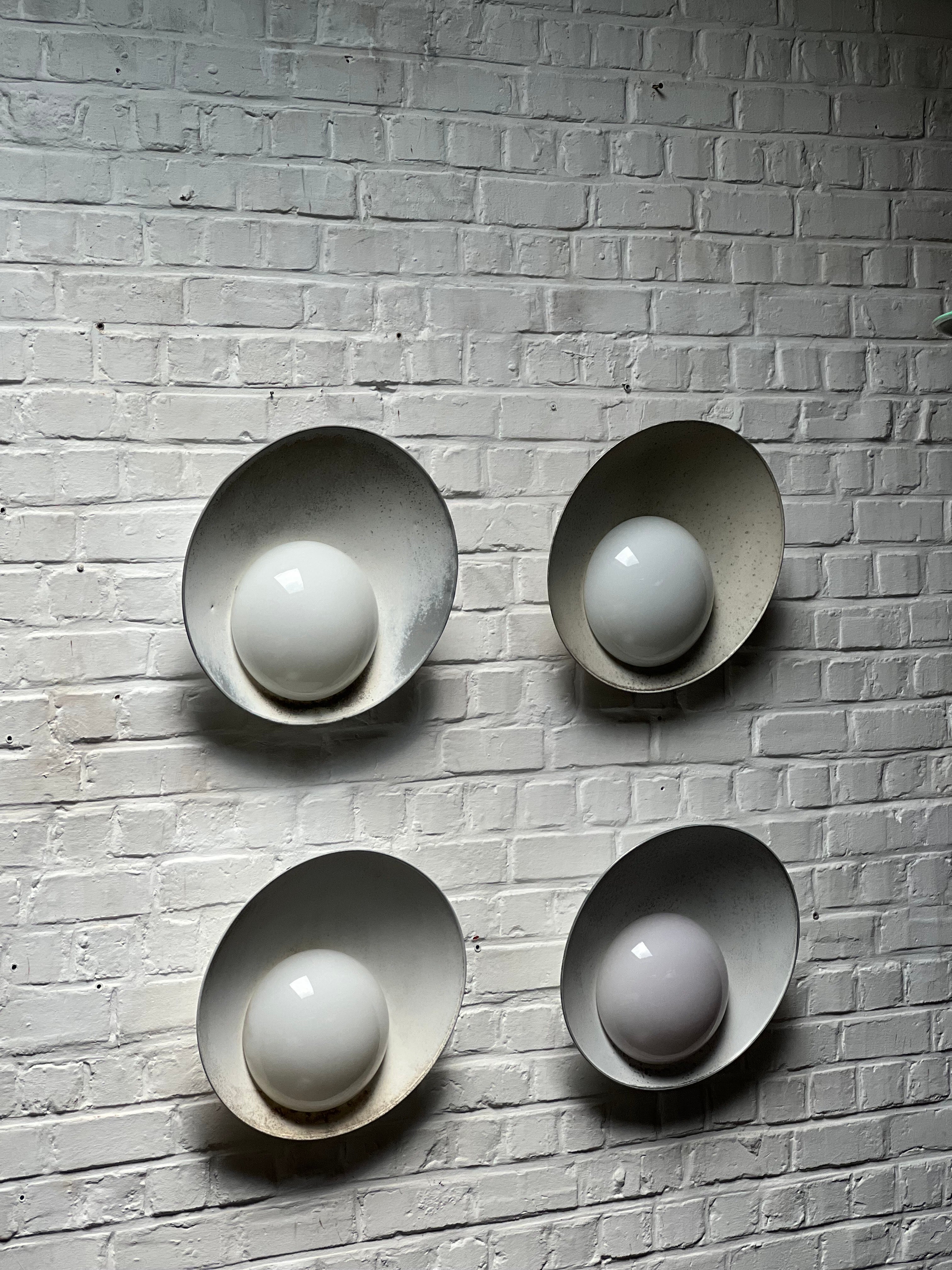 Set of 4 untouched and patinated trough time lamps by master Danish architect Vilhelm Lauritzen. The lamps were designed for the Kastrup airport in Copenhagen (1937-39) and produced by Louis Poulsen. Usually they are repainted white but these are