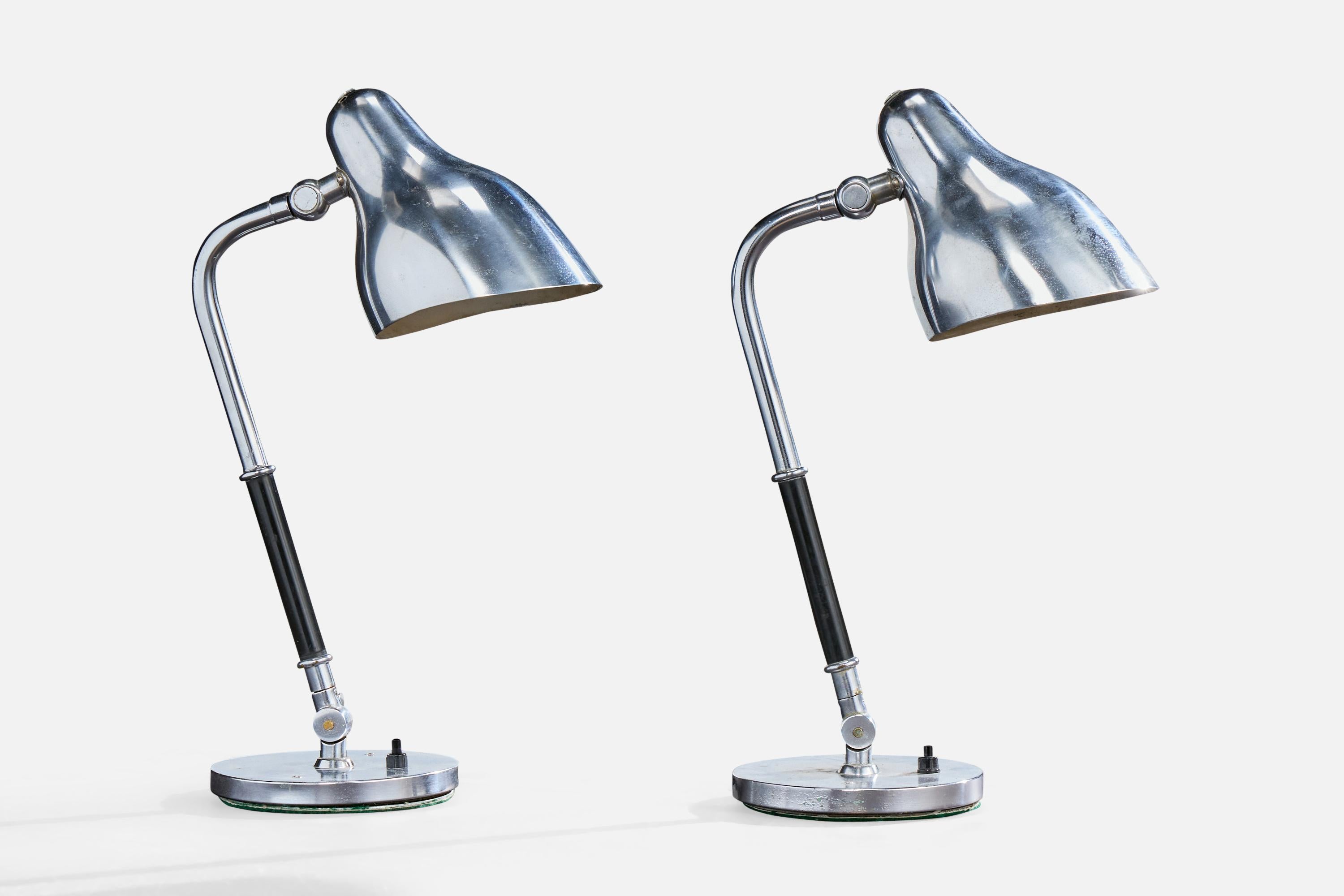 A pair of chrome-plated metal and black bakelite table lamps designed by Vilhelm Lauritzen and produced by Lyfa, Denmark, c. 1940s.

Dimensions of Lamp (inches): 16.0