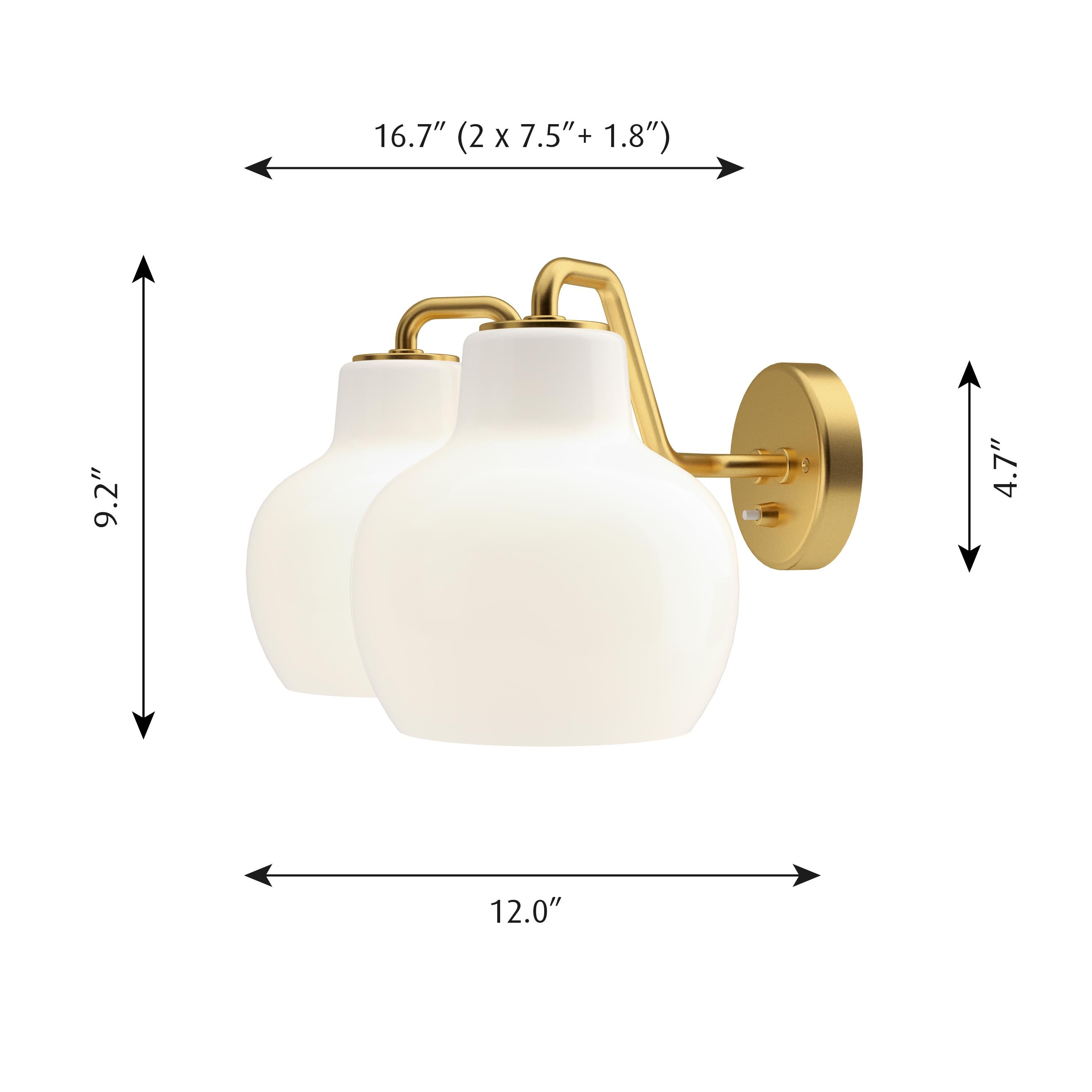 Vilhelm Lauritzen VL-2 brass and glass wall lamp for Louis Poulsen. Executed in two hand blown glossy white opal glass shades and unfinished satin polished brass armature and backplate. The sconce emits light directed primarily downwards. The opal