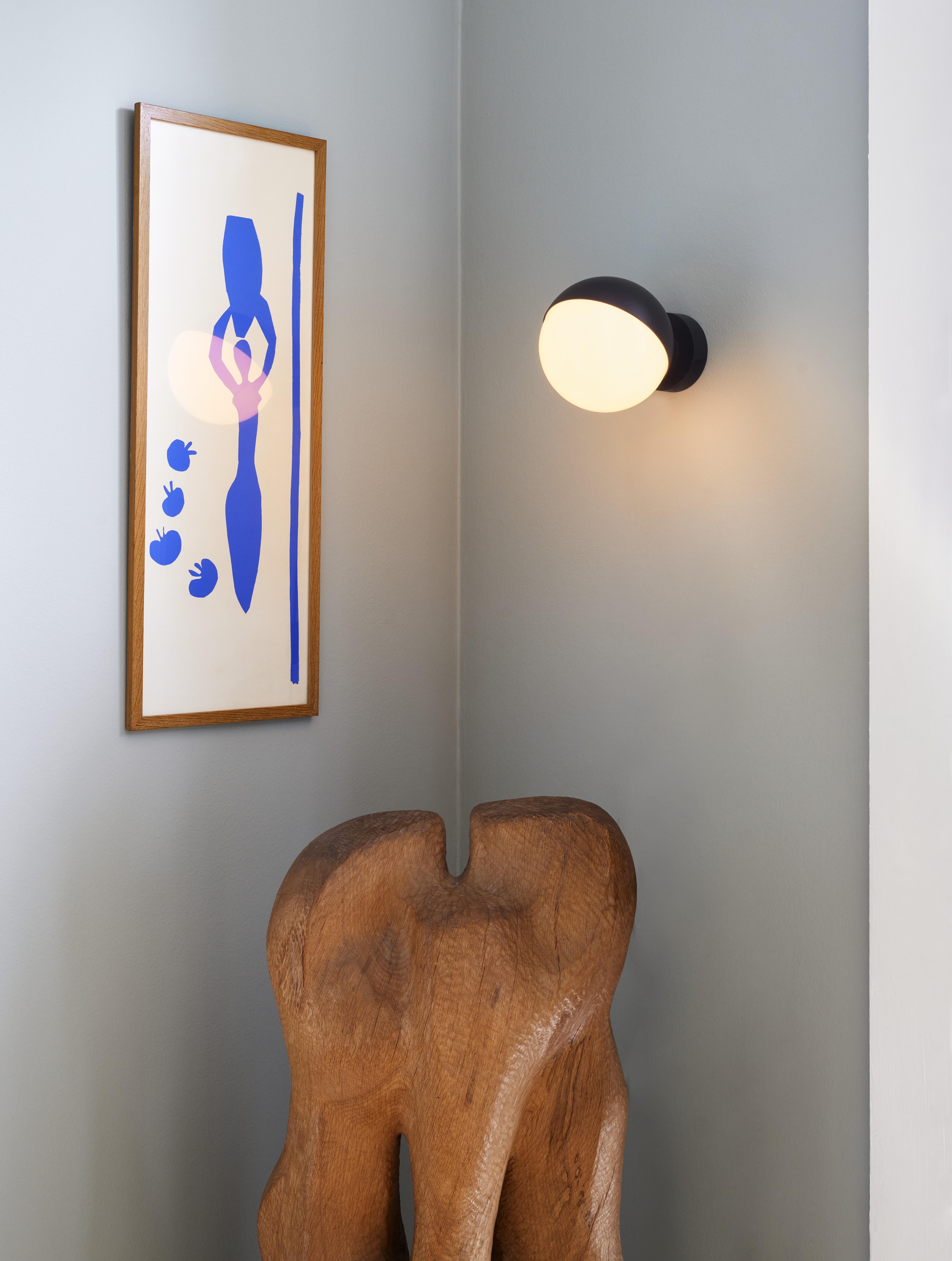 Vilhelm Lauritzen 'VL Studio' metal and glass wall lamp for Louis Poulsen.

This innovative lamp is based on Lauritzen's original studio wall lamp for Radiohuset, which indicated with a red or green light whether the studio was recording. This