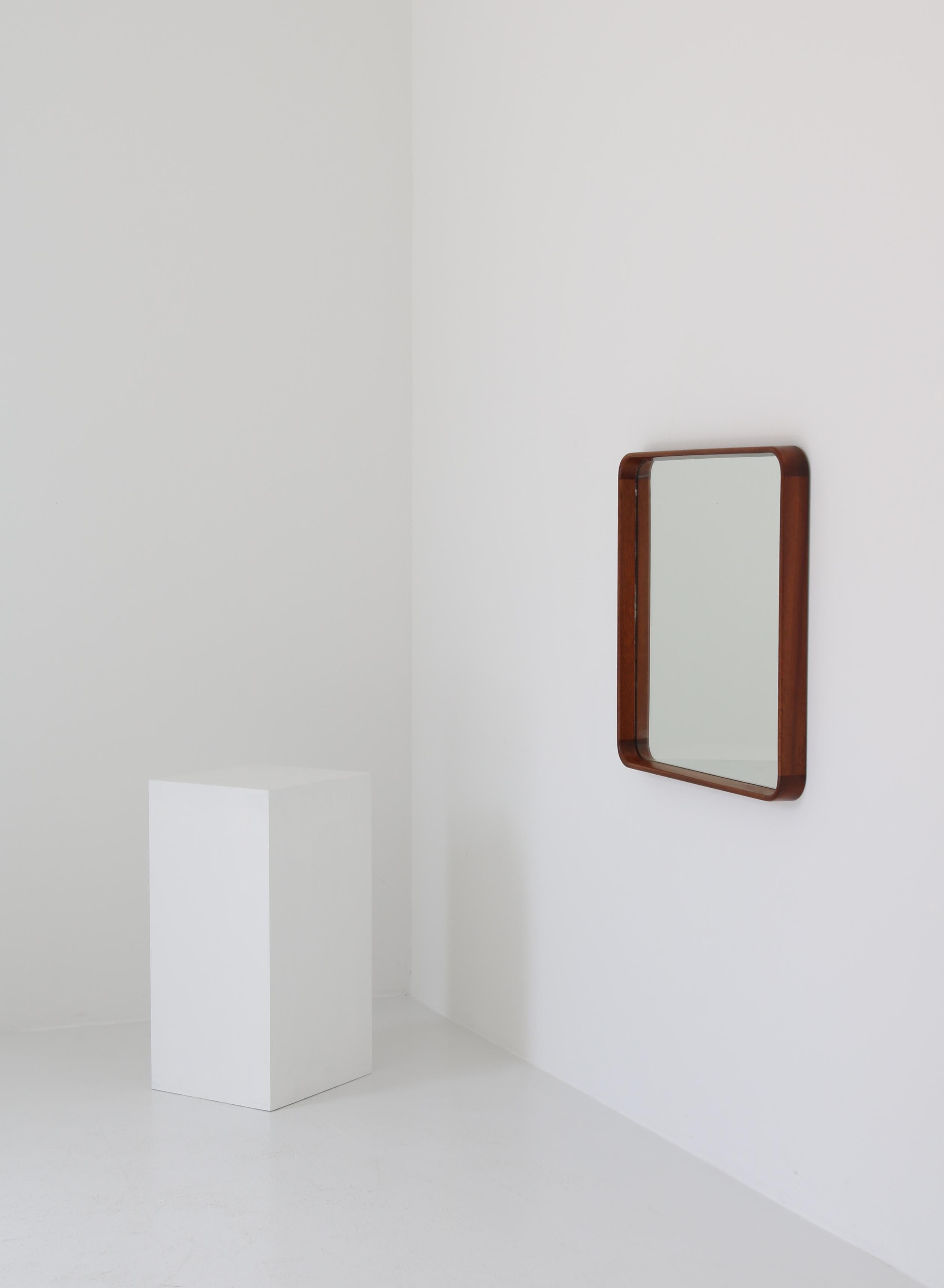 Rare wall mirror designed by Danish architect Vilhelm Lauritzen and executed in selected solid mahogany with a beautiful grain. Classic 1930 functionalism and superior craftsmanship makes this amazing piece a wonderful addition to any interior