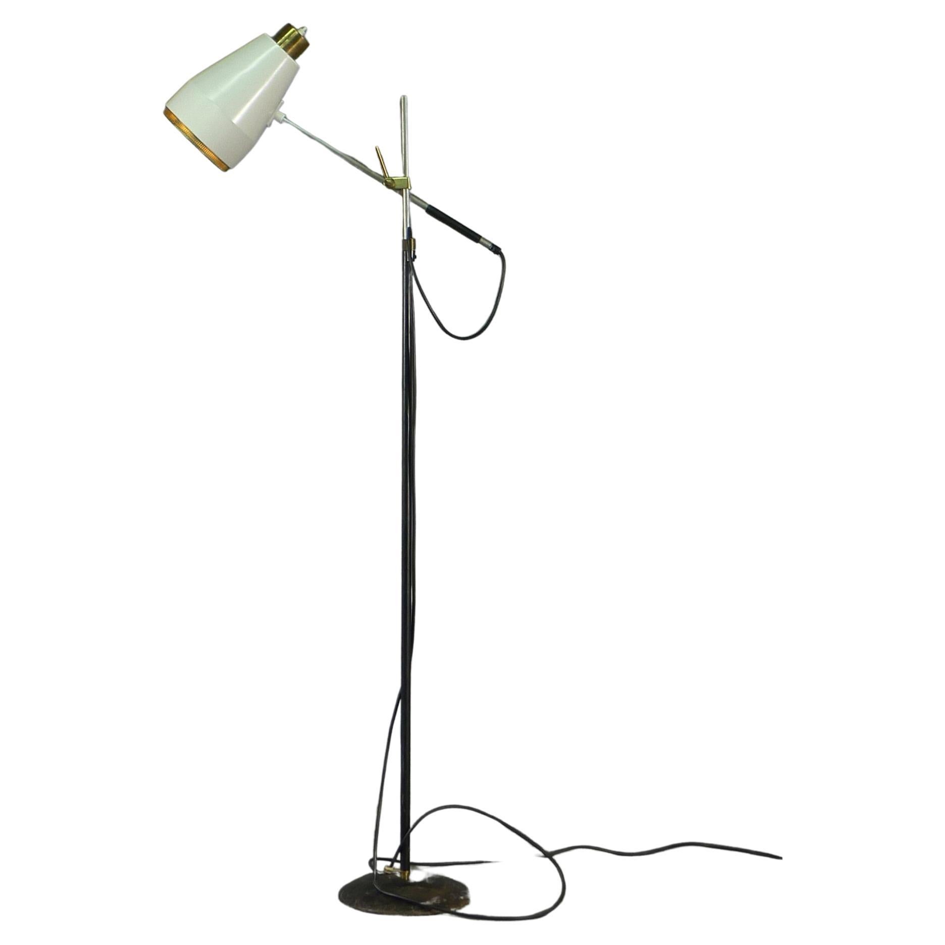 Viljo Hirvonen (1916-1975) Floor Lamp model H801, in cast iron, leather, brass and lacquered metal, designed circa 1960 and manufactured by Valaistustyö, Finland

White lacquered shade with perforated brass edging can be moved to where light is