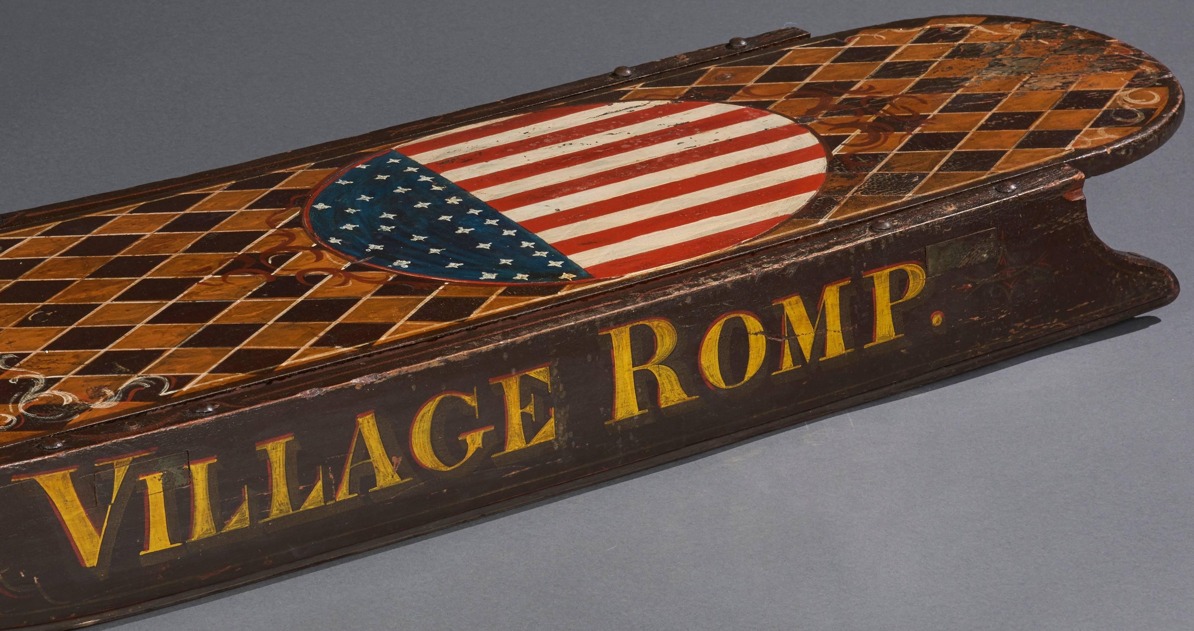 Yankee clipper type sled christened village romp with outstanding paint from New England, circa 1880. Graphically pleasing American shield on a checkerboard background. Metal stand for upright display available.