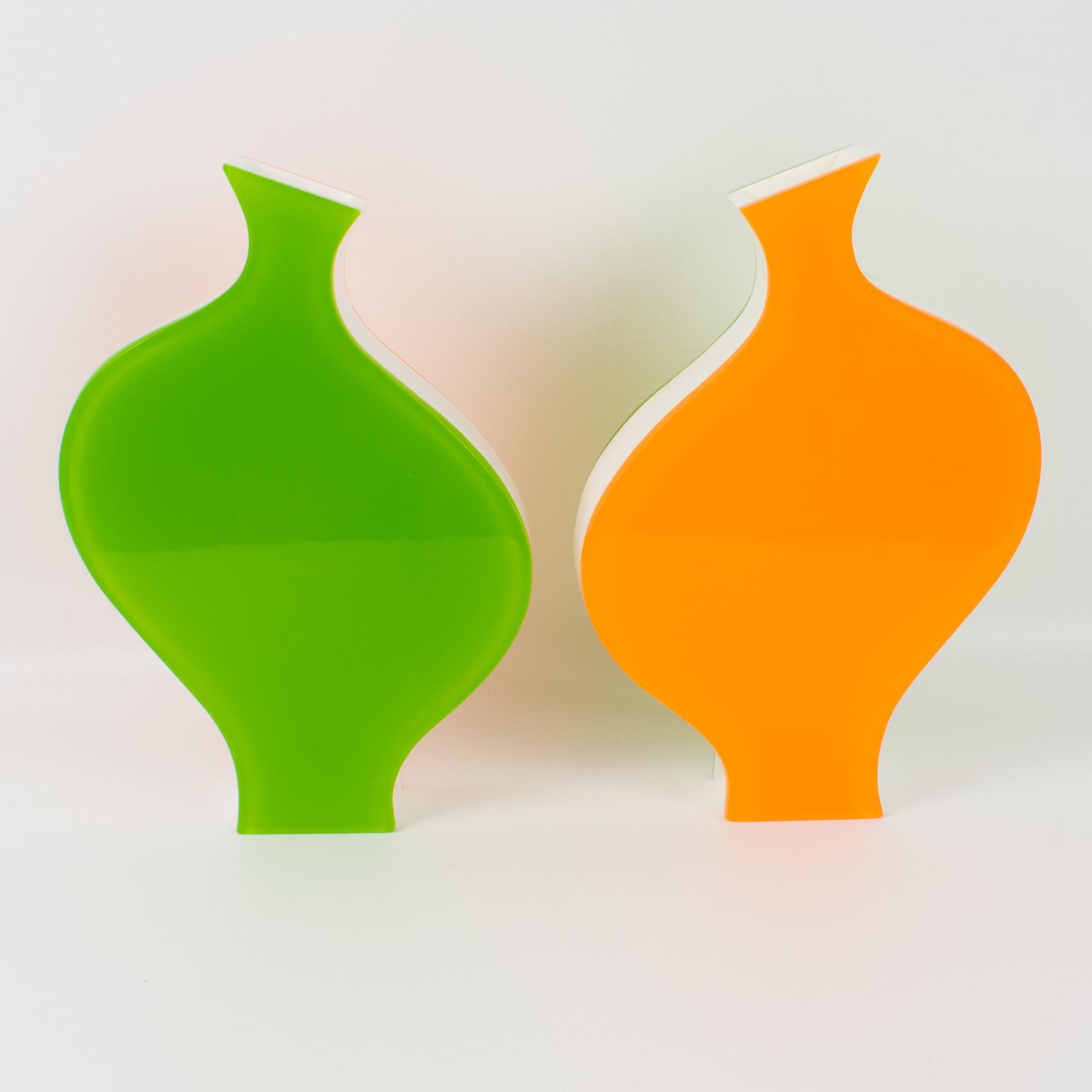 Villeroy & Boch produced that lovely pair of vases in the 1990s. This playful design is modern with an incredible color combination. Each vase is built with a multilayer sandwich shape of Lucite or Plexiglass in tangerine orange, white, and apple