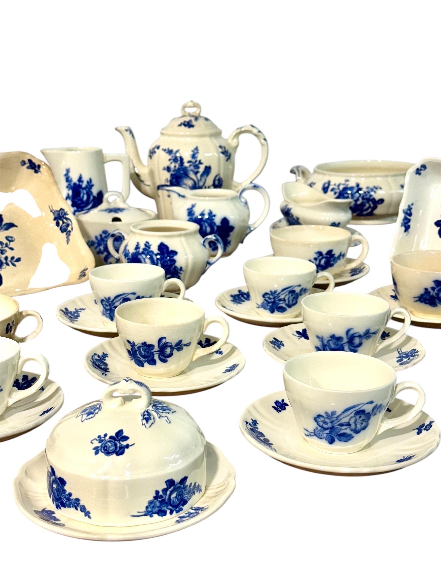 This mid-20th century dinnerware service by Villeroy & Boch, Germany, showcases the timeless charm of blue floral decoration on a creamy white ground. Executed in fine faience, the set reflects the brand’s long-standing tradition of craftsmanship