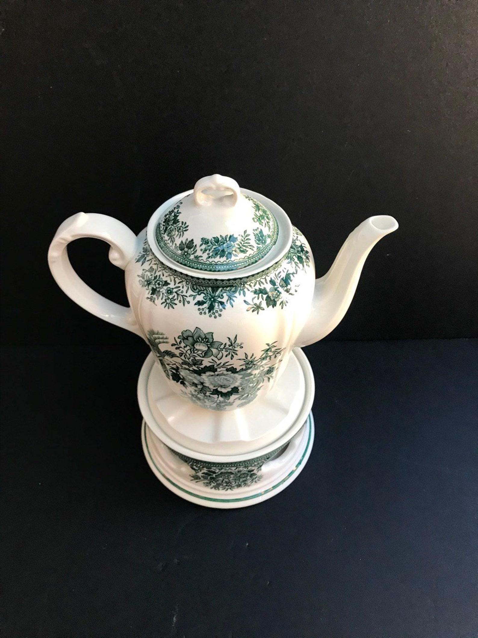 Villeroy & Boch Fasan.

Delightful Vintage Green and White Porcelain Teapot with Warmer Stand. Manufactured in West Germany by Villeroy & Boch. 

Pattern: Fasan (Pheasant)

Vitro porcelain. 

An interesting, worthy thing for serving a