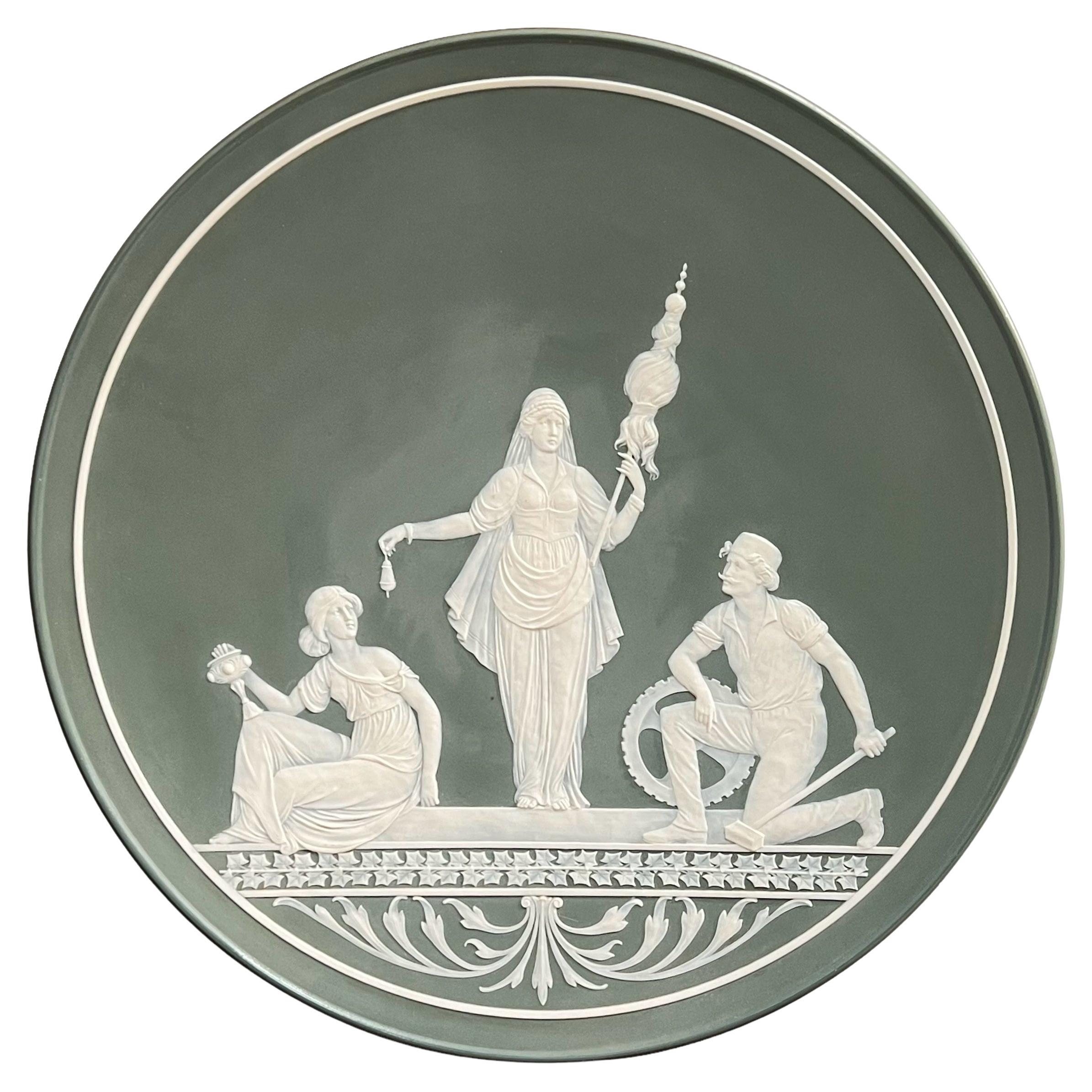 Villeroy & Boch Mettlach charger in Phanolith porcelain (similar to Jasperware) depicting a Greco-Roman goddess and attendants in white porcelain on a forest green ground.  In very good condition.