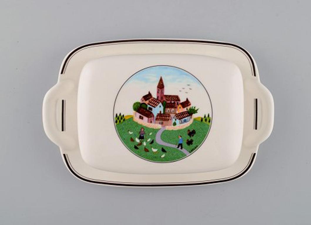 Villeroy & Boch Naif butter container with dish in porcelain decorated with naivist village motif.
In very good condition.
Stamped.
Measures: 22.5 x 14.5 x 5.5 cm.
Designed by Gérard Laplau. Motives of families, villages and biblical scenes in