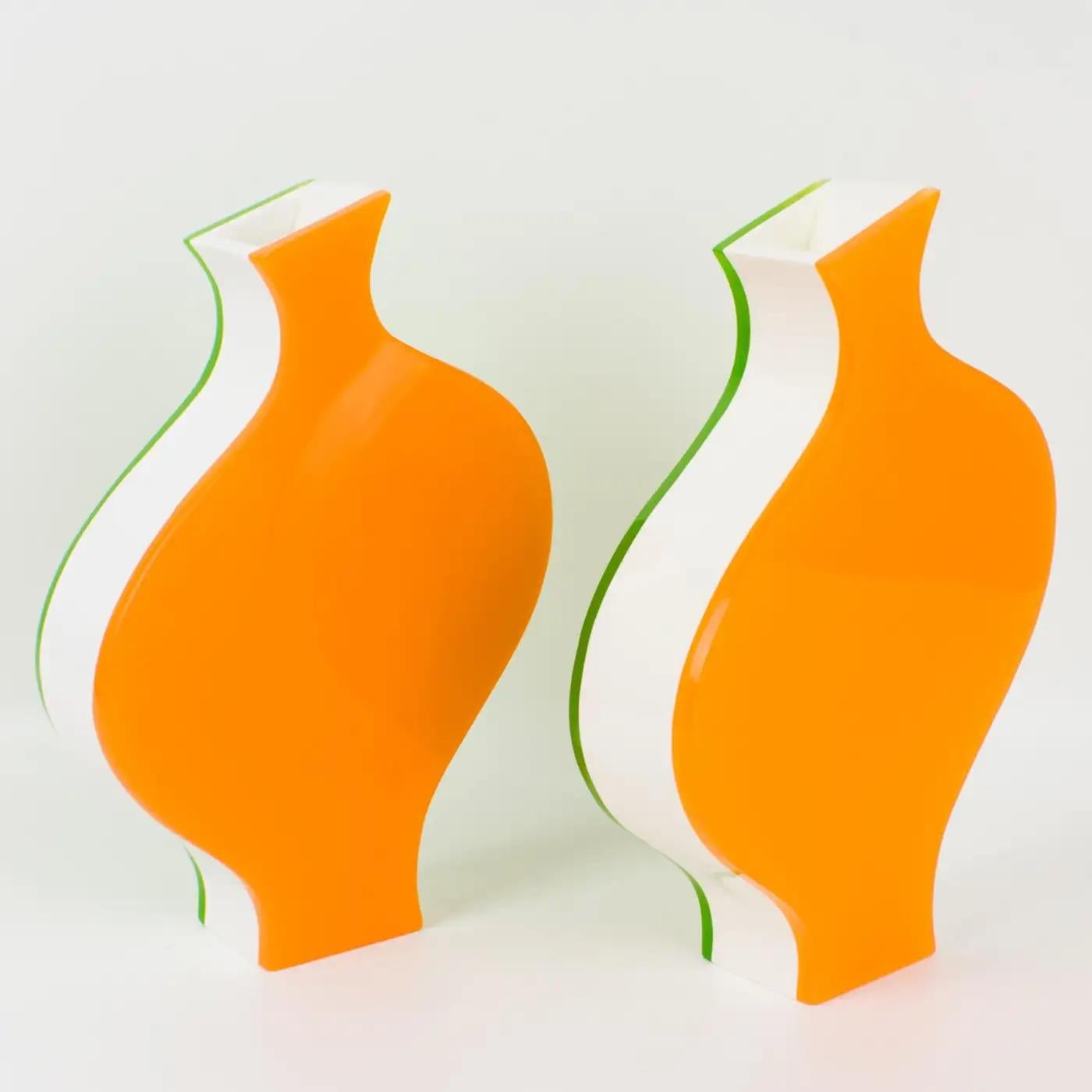Villeroy & Boch produced that lovely pair of vases in the 1990s. This playful design is modern with an incredible color combination. Each vase is built with a multilayer sandwich shape of Acrylic, Lucite, or Plexiglass in tangerine orange, white,