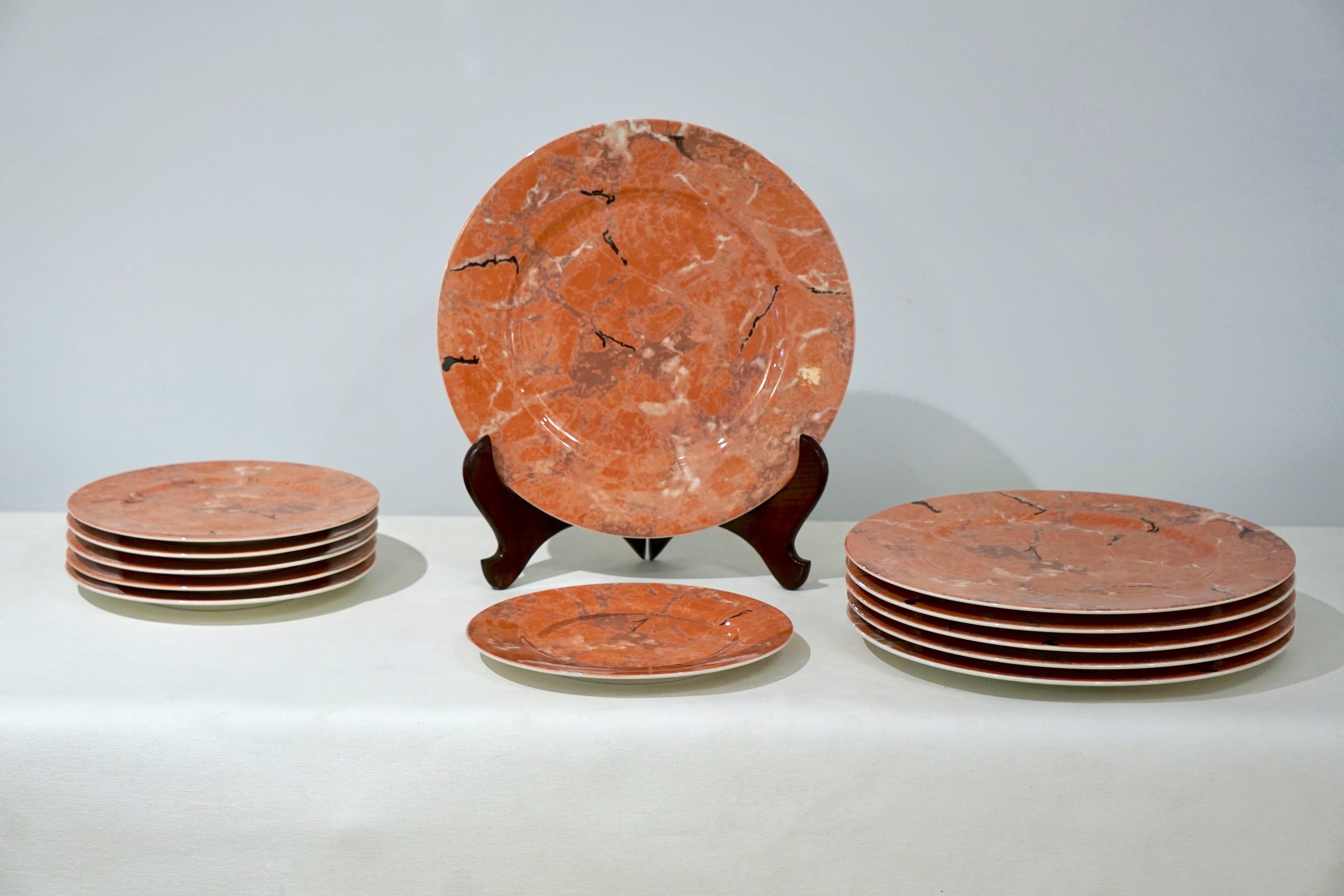 A set of 12 pieces, 6 large plates / placemats and 6 smaller dessert/cheese plates, a  discontinued production in vitro porcelain by the European Villeroy & Boch company, decorated in a variegated pattern to resemble marble, in orange pink Siena