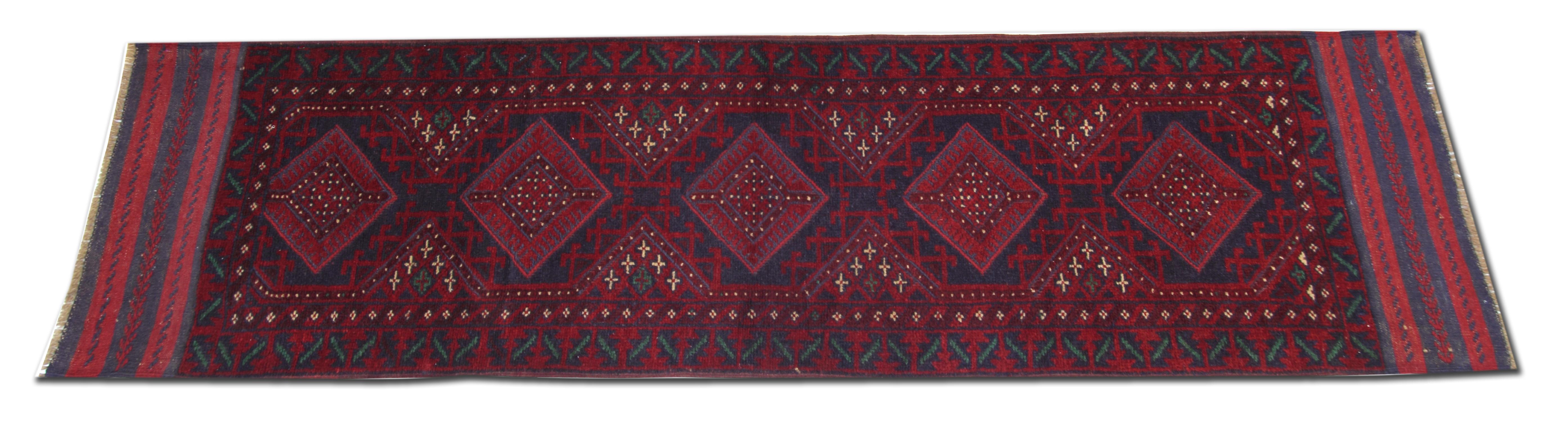 This impressive antique red rug is made from our master weavers in Afghanistan. These particular handmade carpet runners are made with all-natural vegetable dyes. The patterned rugs display an all-over geometrical rug pattern. This woven rug also