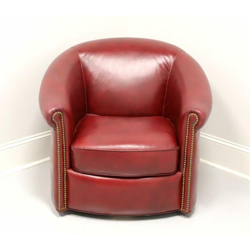 A Contemporary style leather swivel club chair by Bradington Young, for the Private Collection at The Summer House in Highlands, North Carolina, USA. Genuine leather on a wood frame with a metal swivel mechanism. Features soft burgundy colored