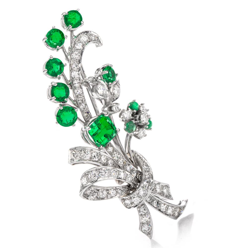 Feature this bouquet on the table.  
This lavish antique floral inspired Art Deco brooch pin features 7 rich and exotic Columbian Emeralds with Extreme transparency and vibrant green color.  Crafted in Luxurious Platinum, This brooch pin contains