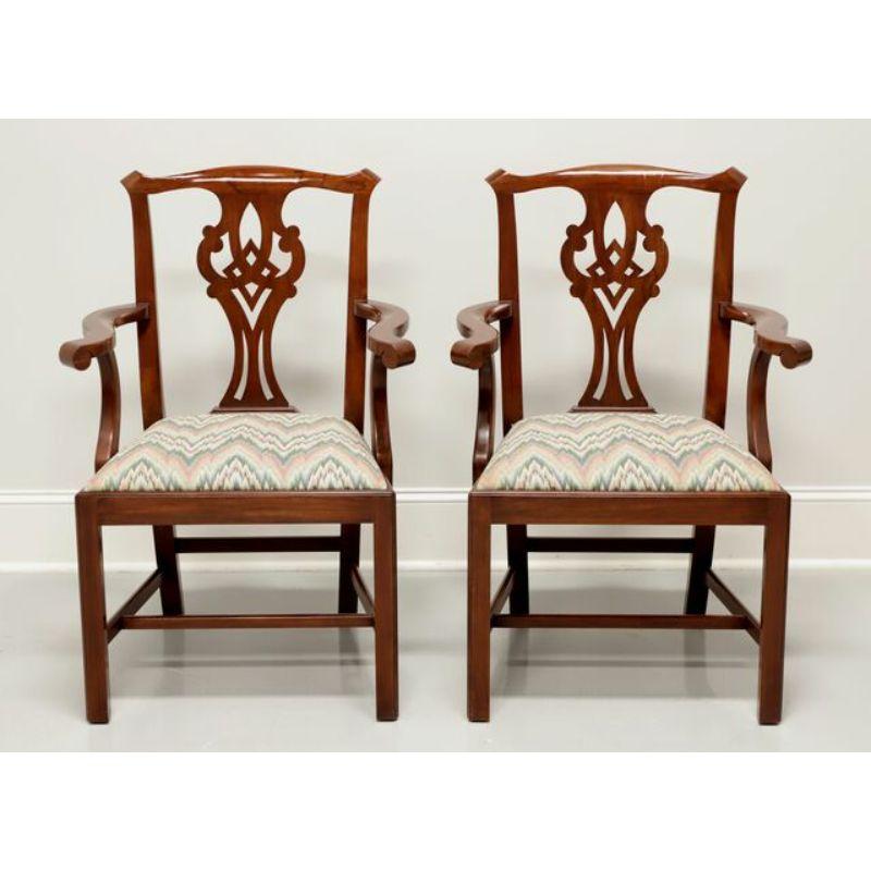 A pair of Chippendale style dining armchairs by Henkel Harris, of Winchester, Virginia, USA. Solid Wild Black Cherry wood with carved backrest, curved arms, flame stitch pattern fabric upholstered seat, straight legs and stretchers. Made circa 1994.