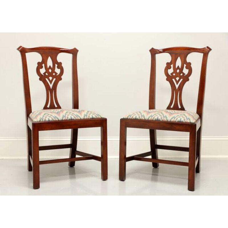 A pair of Chippendale style dining side chairs by Henkel Harris, of Winchester, Virginia, USA. Solid Wild Black Cherry with carved seatbacks, straight legs and flame stitch pattern fabric upholstered seat. Made circa 1994.

Style #: 101S, Finish #: