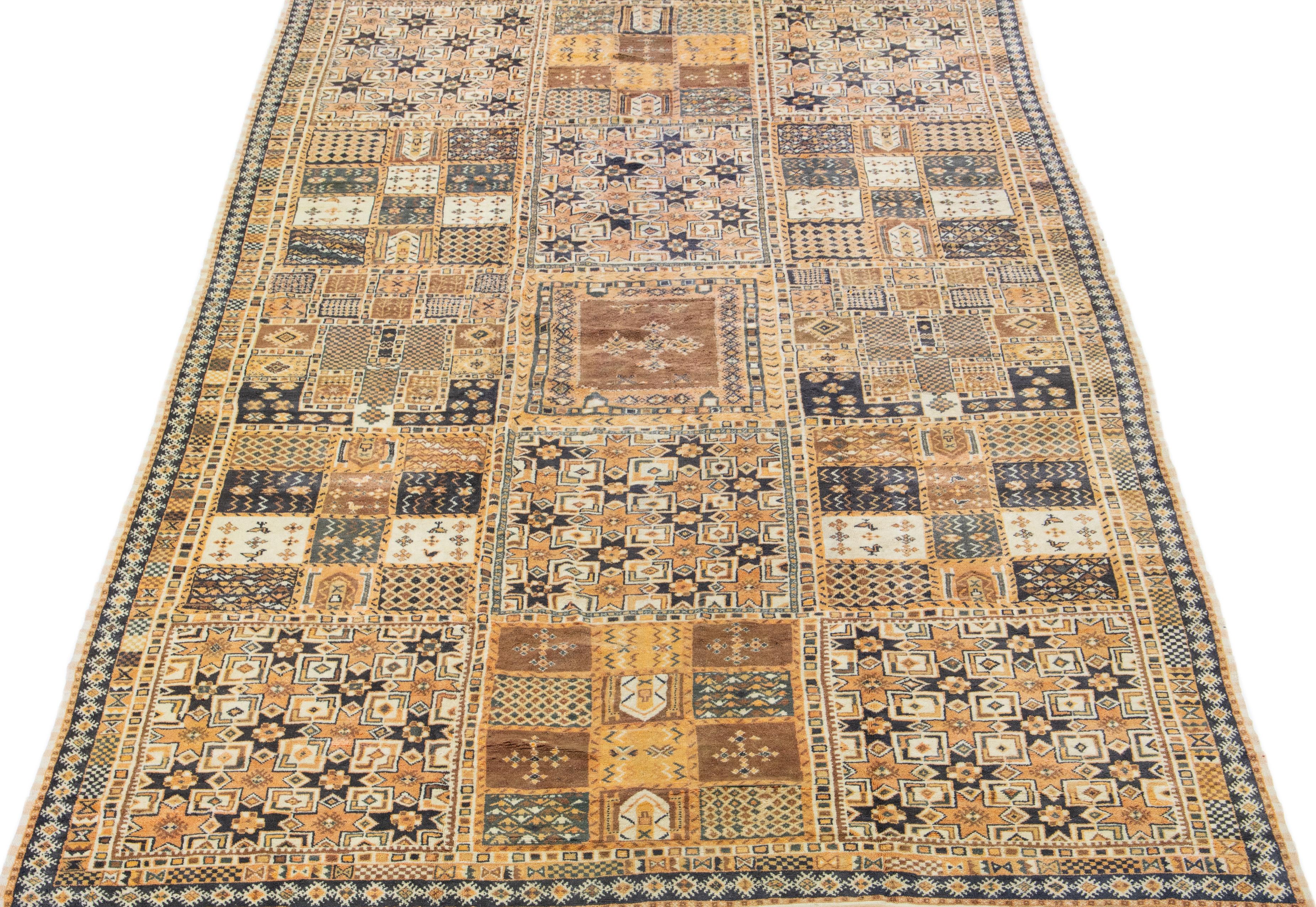 Dieser marokkanische Vintage-Teppich ist mit einem komplizierten geometrischen Muster in einer Reihe von auffälligen Farbtönen, darunter Pfirsich und Grau, versehen. Die Verwendung von hochwertigem Wollmaterial unterstreicht die sorgfältige,