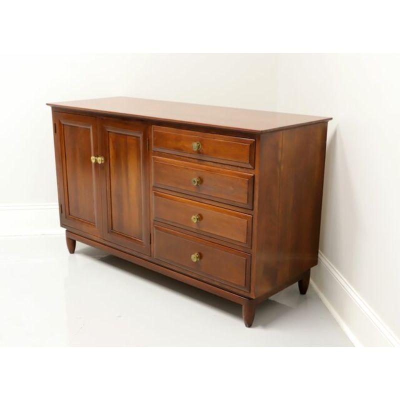 A mid century dresser by Willett Furniture, of Louisville, Kentucky, USA. Solid cherry with brass hardware. Features right side with four various size drawers of dovetail construction. Left side with dual doors revealing four more dovetail drawers,