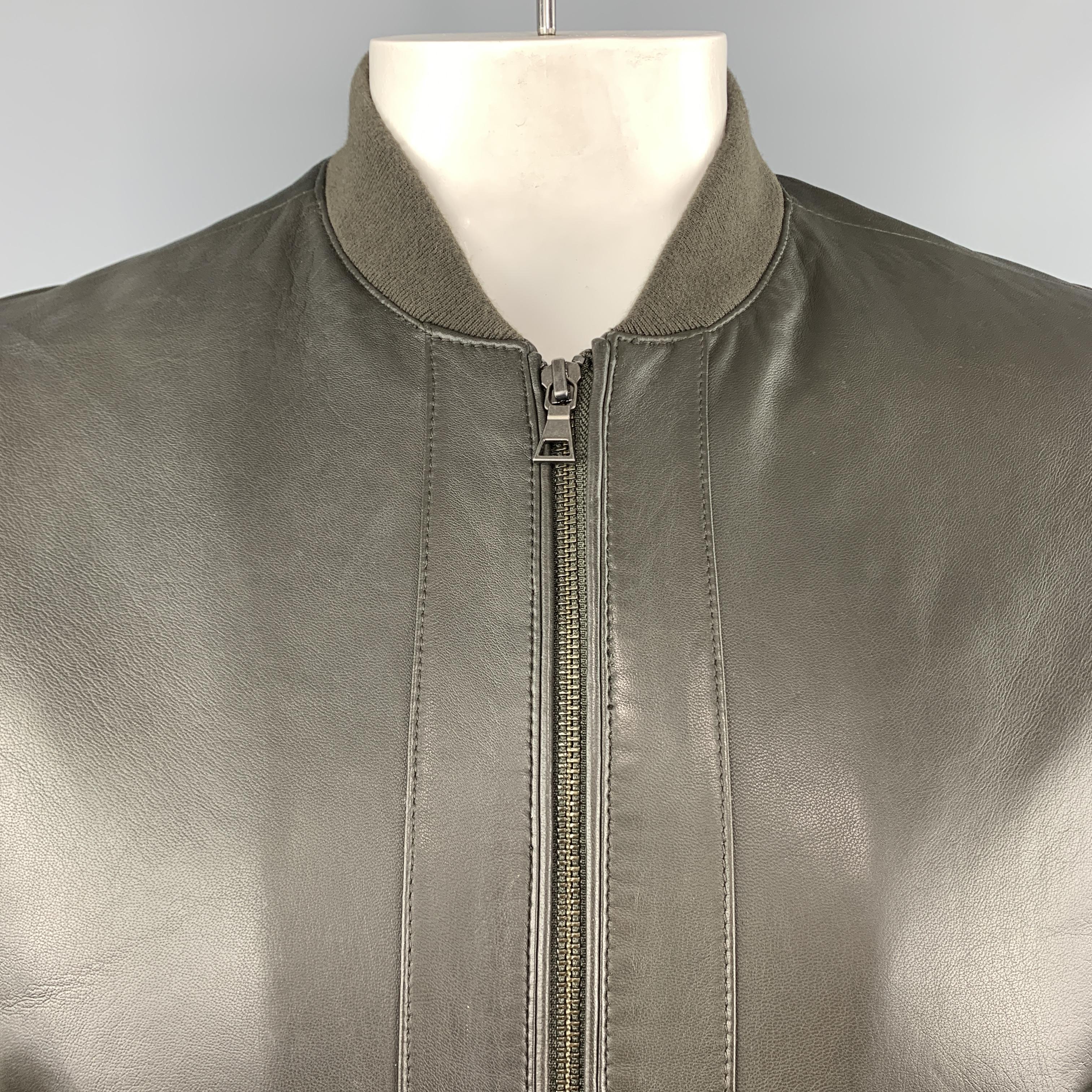 VINCE bomber jacket comes in deep olive green leather with a baseball collar, slanted zip pockets, and quilted suede sleeves.
 
Excellent Pre-Owned Condition.
Marked: L
 
Measurements:
 
Shoulder: 19 in.
Chest: 48 in.
Sleeve: 25.5 in.
Length: 27.5