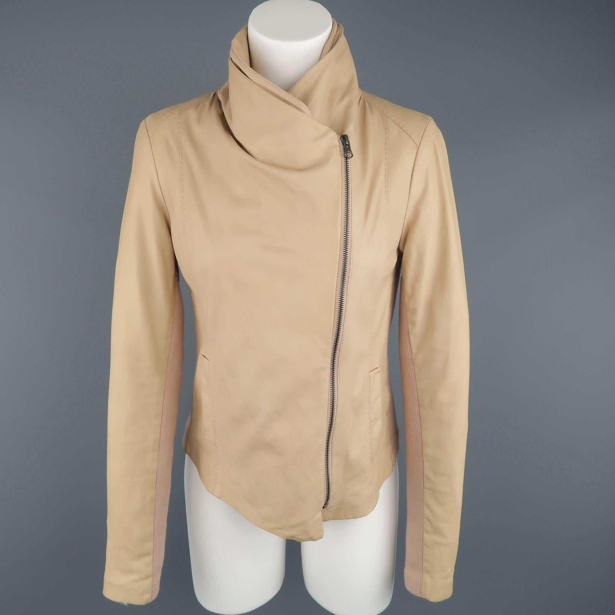 VINCE avant garde biker jacket comes in a light weight beige matte leather and features a draped collar, asymmetrical zip front, slit pockets, peachy beige ribbed panels, and top stitching throughout.  Retailed @ $995.00
 
Good Pre-Owned