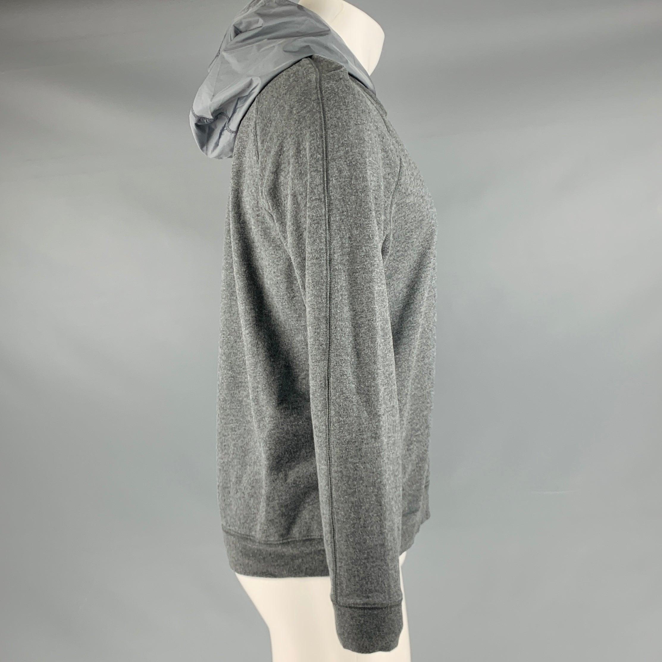 VINCE sweatshirt
in a heather grey cotton blend fabric featuring a faux layer with hood style.Very Good Pre-Owned Condition. Minor signs of wear. 

Marked:   M 

Measurements: 
 
Shoulder: 17.5 inches Chest: 40 inches Sleeve: 24.5 inches Length: 25