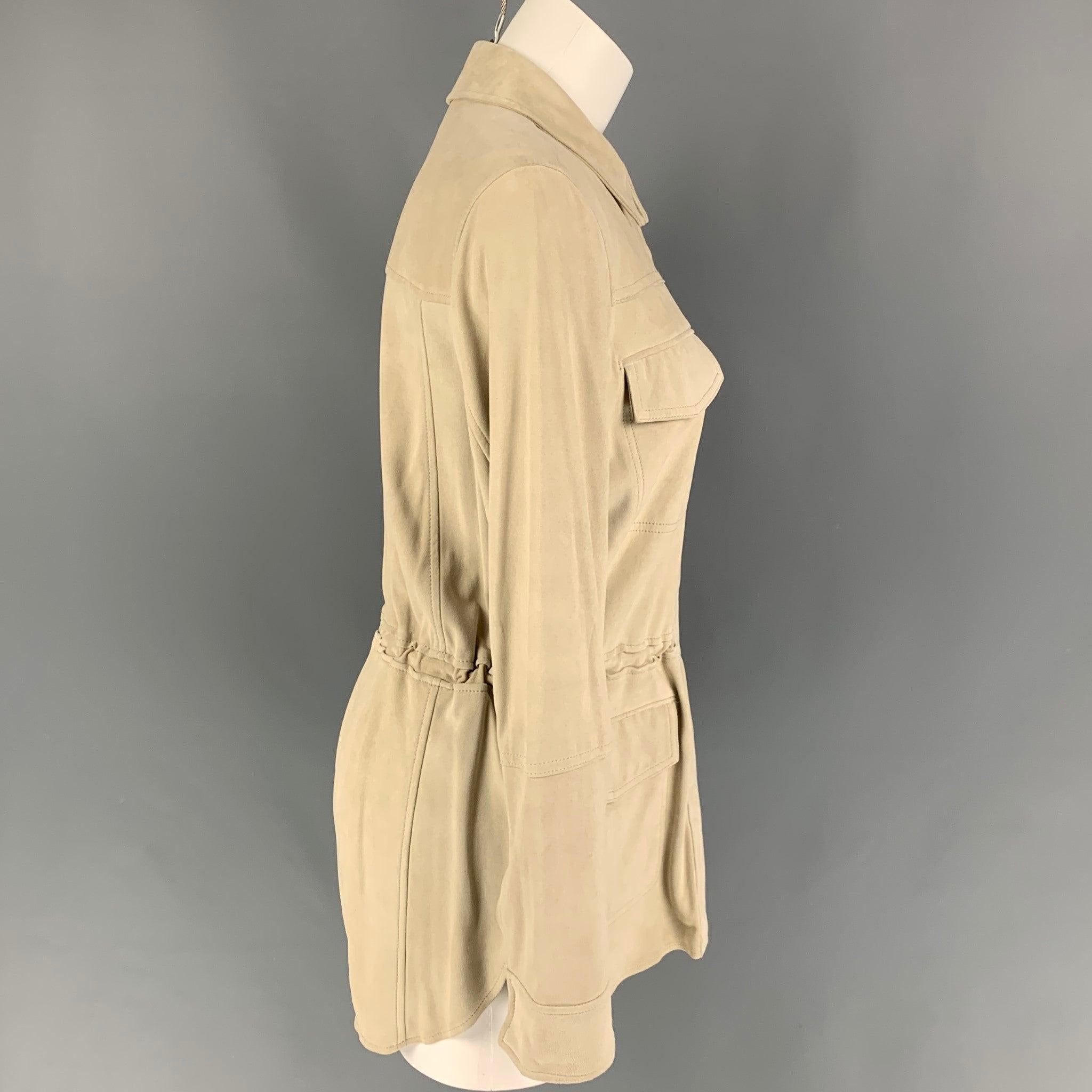 VINCE parka jacket comes in a beige suede featuring a waist drawstring, patch pockets, spread collar, and a snap button closure.
New With Tags. 

Marked:   S 

Measurements: 
 
Shoulder: 16 inches  Bust: 38 inches  Sleeve: 25.5 inches  Length: 31