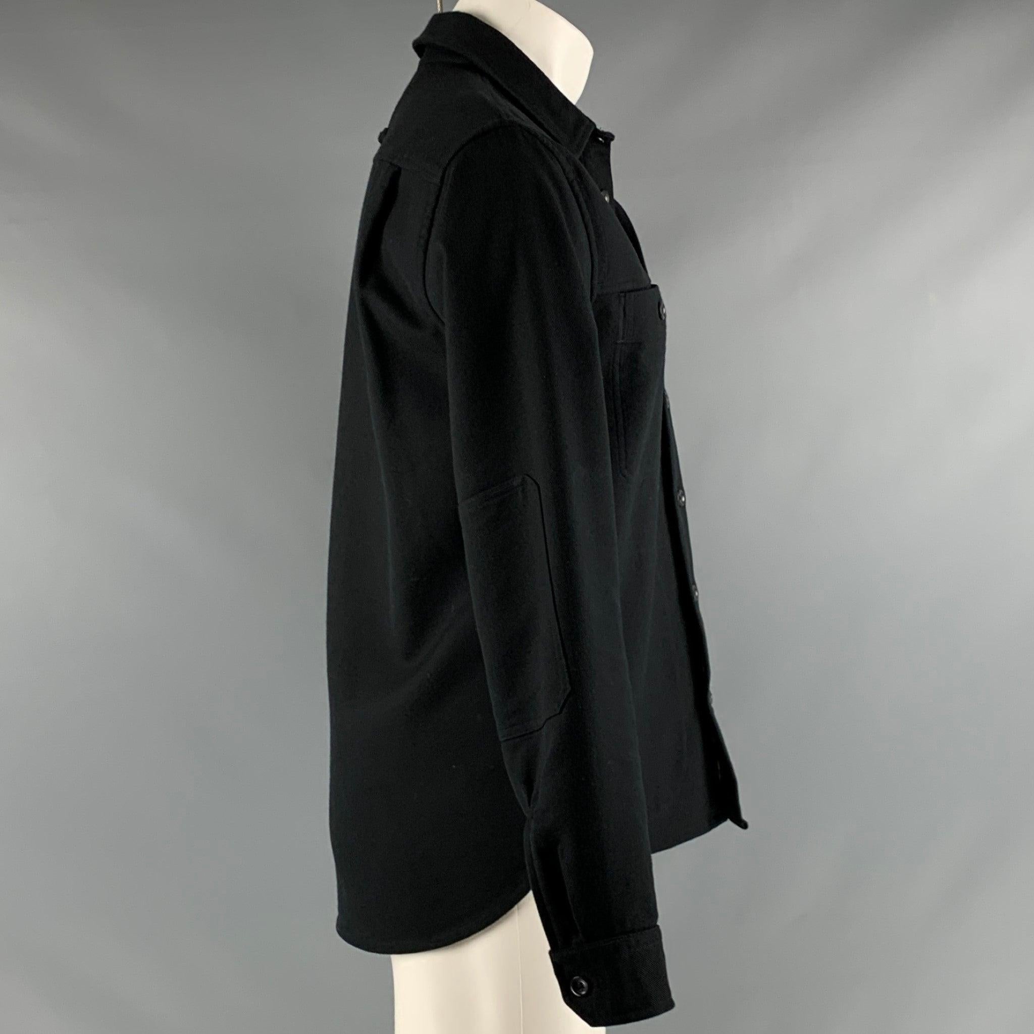 VINCE jacket
in a black cotton blend fabric featuring subtle black elbow patches, four pockets, and a button closure. Excellent Pre-Owned Condition. 

Marked:   S 

Measurements: 
 
Shoulder: 18 inches Chest: 38 inches Sleeve: 24.5 inches Length: 28