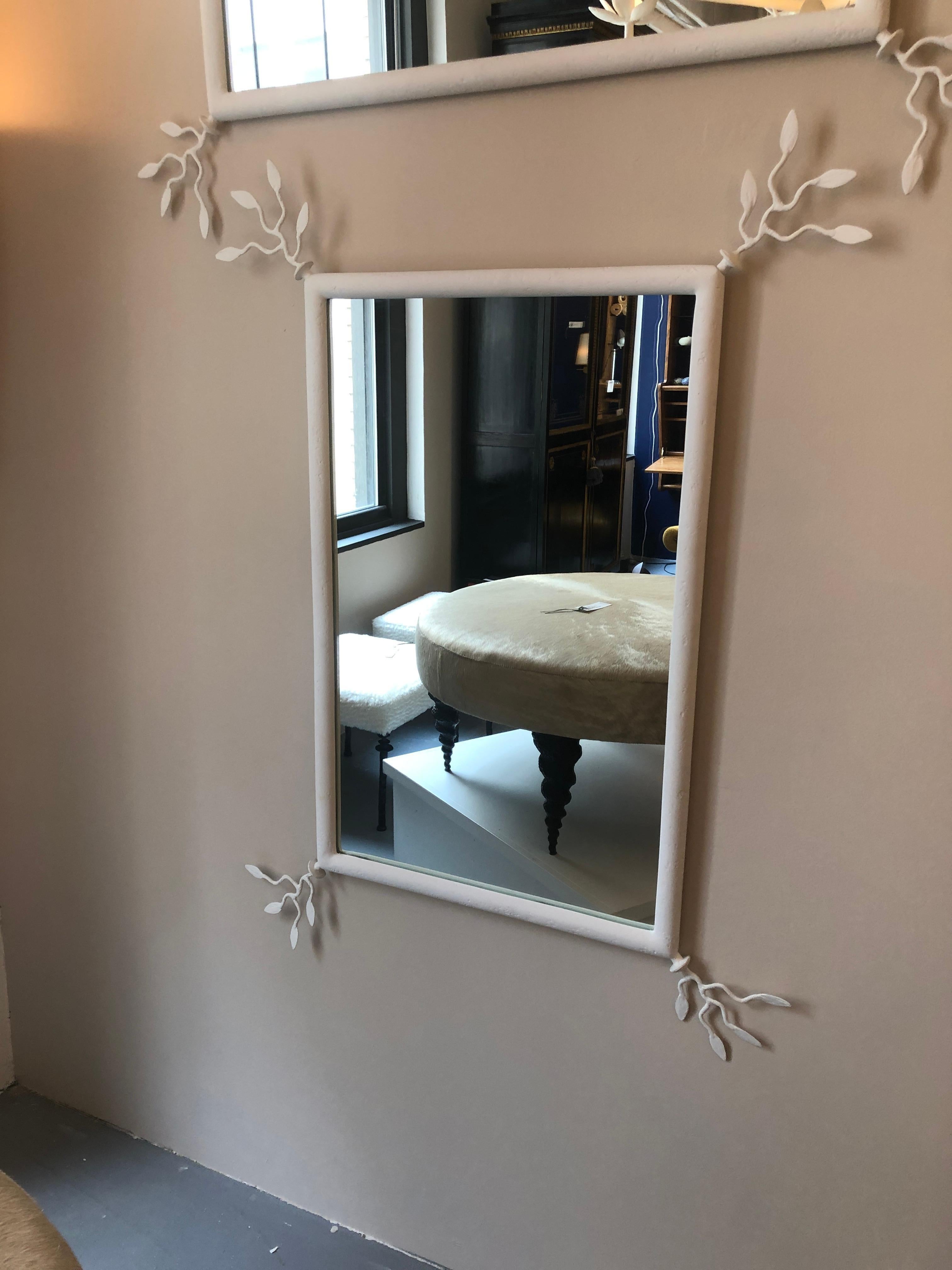 Unique Wall mirror with a plaster of Paris finish. White matte finish. Delicate leaf motif decorate each corner and are also covered in the plaster finish. Can be hung both vertically and horizontally. The dimensions of the mirror listed in this