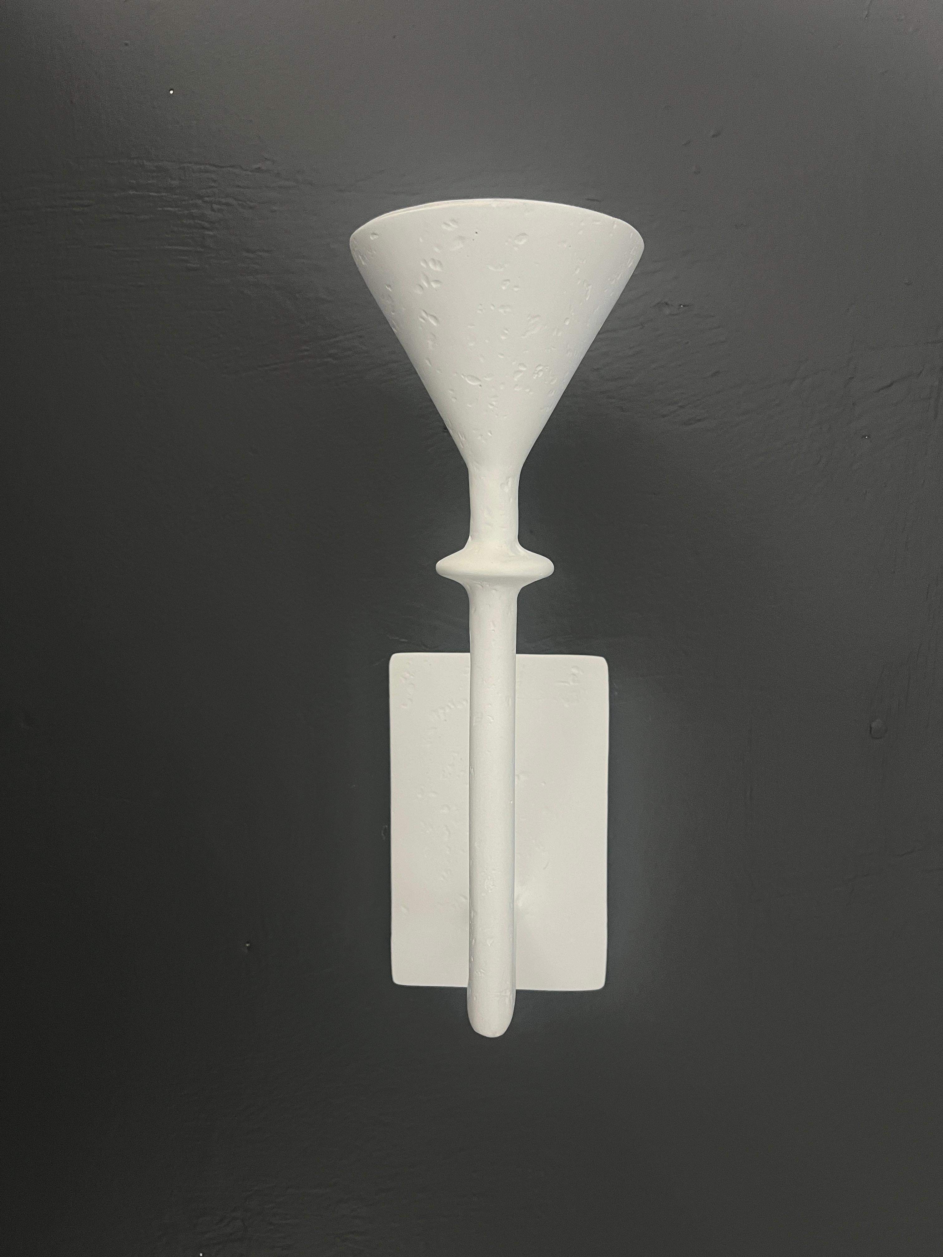 Introducing the Vincennes Primo Sconce, a masterpiece of lighting design that transcends mere illumination to become a work of art. This exquisite wall sconce boasts an organic plaster of Paris finish, evoking the timeless elegance of French