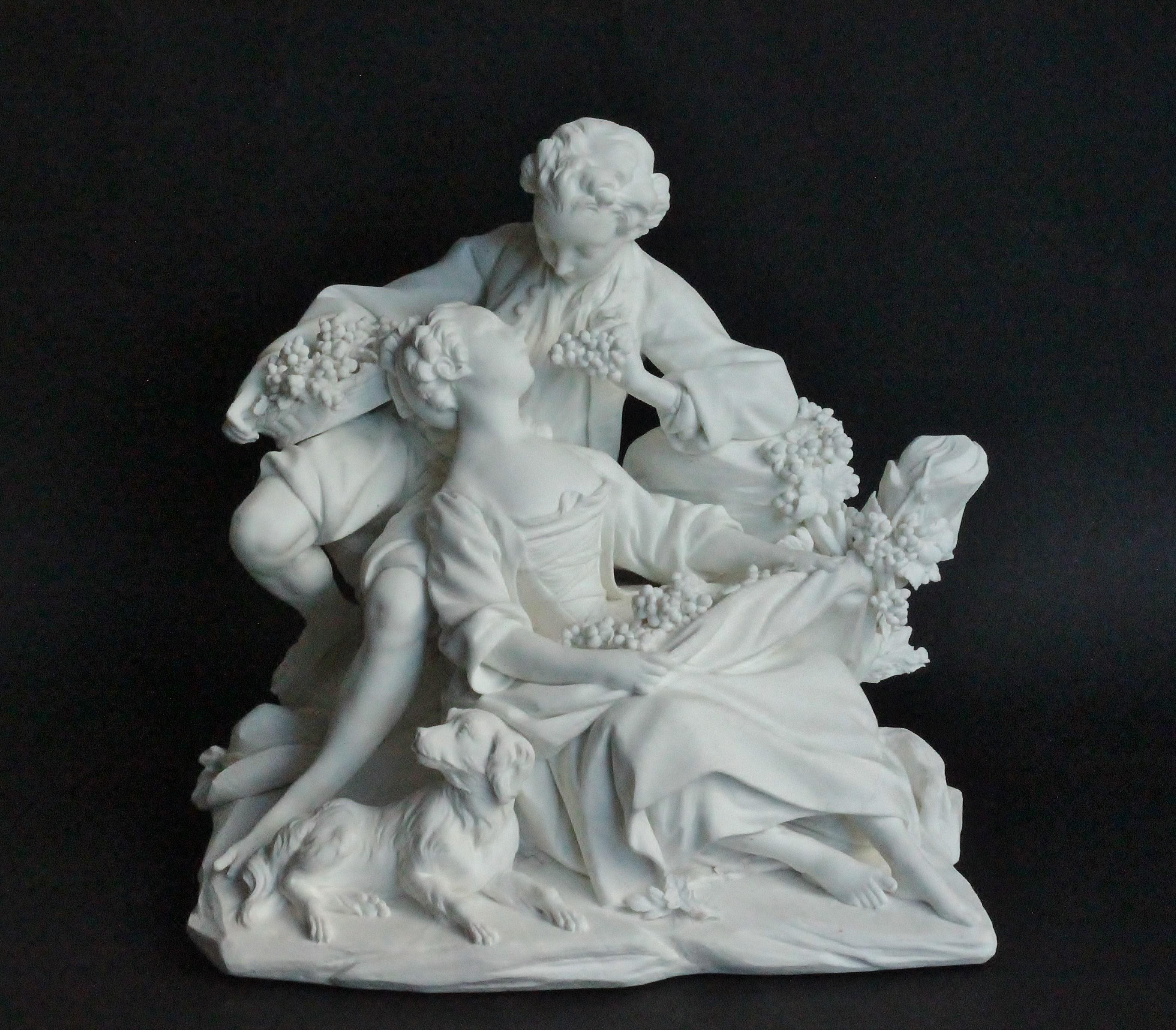 Biscuit group in Vincennes-Sèvres porcelain, modelled as a gallant and companion, she reclining as he offers her grapes from a basket, a dog, his hat and a fallen flower on the ground before them, on a shaped rockwork base, circa