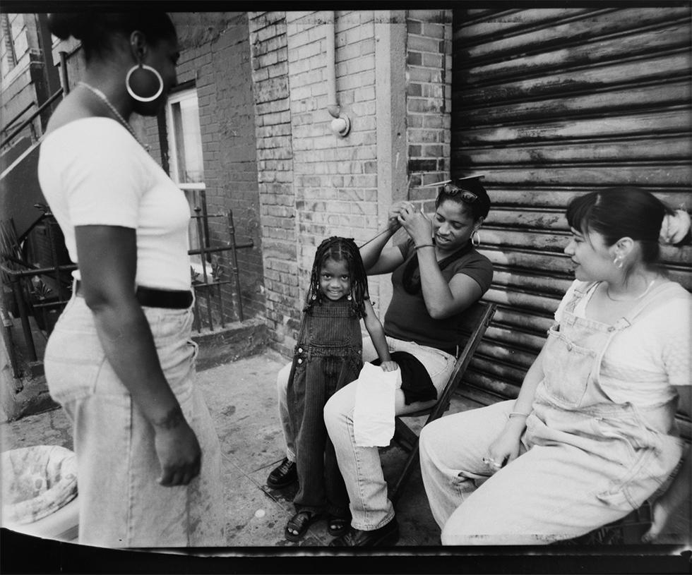 Vincent Cianni Portrait Photograph - Monica Braiding Destiny's Hair, South 2nd Street, Williamsburg, Brooklyn