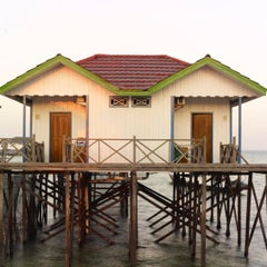 Borneo 1: stilt house architecture in water landscape at sunrise, Southeast Asia