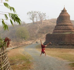 Myanmar 1: child Buddhist monk playing by Southeast Asia temple landscape