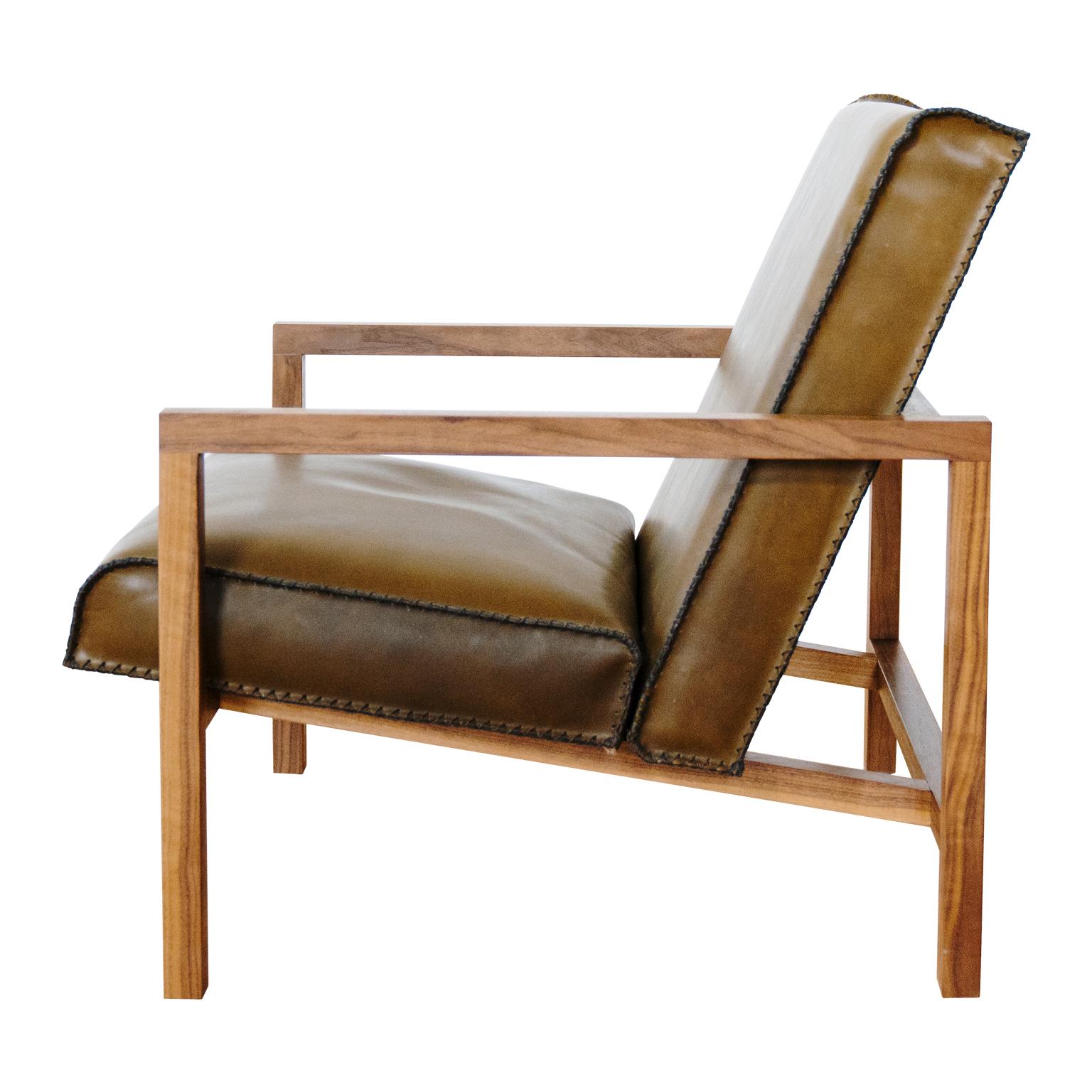 The Vincent lounge chair features a heritage leather seat and back and finely crafted black walnut wooden frame. 
Displayed here in olive green leather, the Vincent is a true statement piece, sure to be noticed and make a Stand out impression in