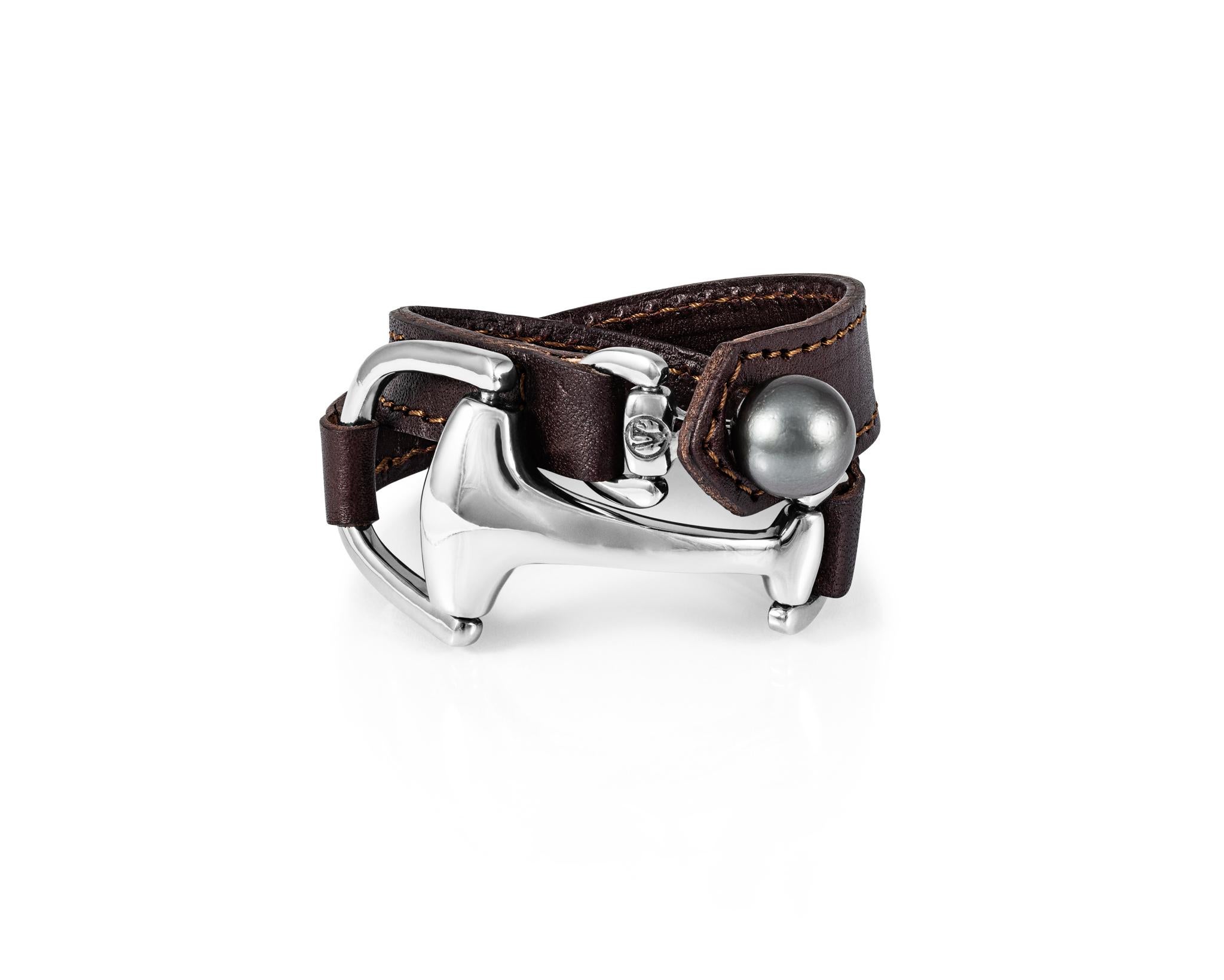 Part of the Vincent Peach Equestrian Collection, the signature Montana Cuff Bracelet and Choker has a Sterling Silver Snaffle Bit with Stitched, Premium-Quality Bovine Leather and a 13-14 mm Tahitian Pearl Clasp. Comes in standard 7