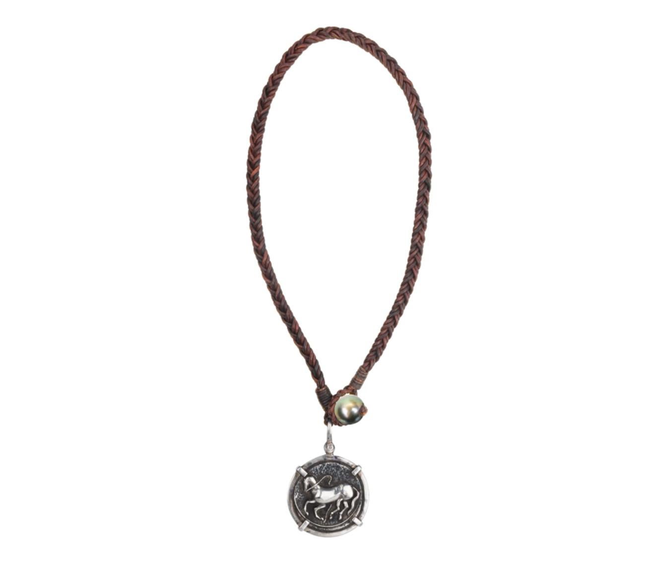 Part of the Vincent Peach Coin Collection, the Trojan Coin Necklace features a signature, Sterling 
Silver Trojan Coin on a Premium Braided Leather Cord with a luxurious, Tahitian Pearl Clasp. This necklace comes in Standard 17