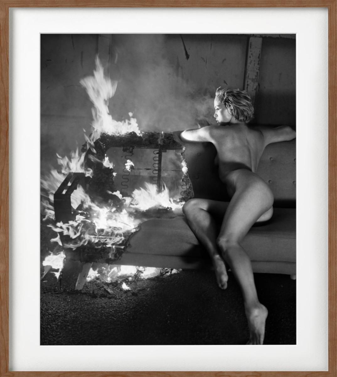 Victoria Fire for Playboy i- b&w photograph nude model sitting on a burning sofa - Black Portrait Photograph by Vincent Peters