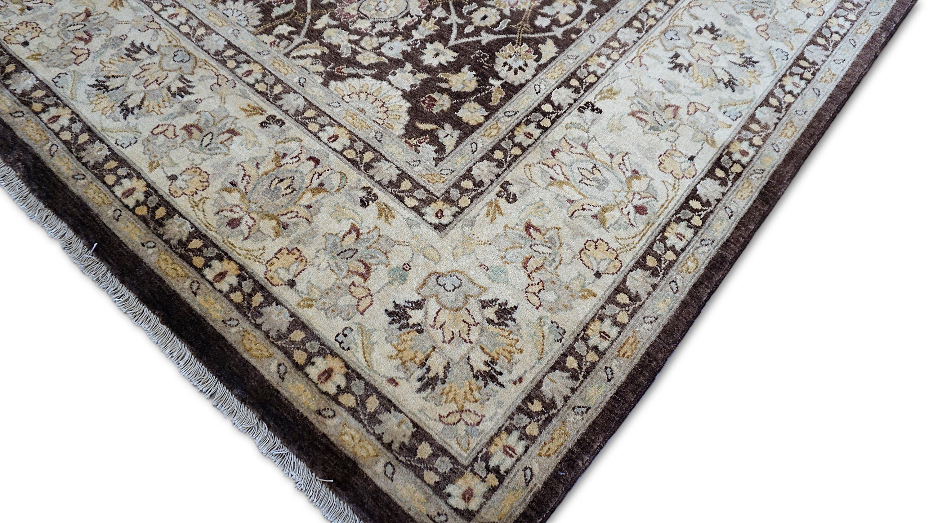 This exquisite hand-knotted Sultanabad rug, crafted in Pakistan, features a deep chocolate brown field adorned with intricate floral and vine motifs, framed by an elegant ivory and taupe border. Inspired by the traditional designs of early