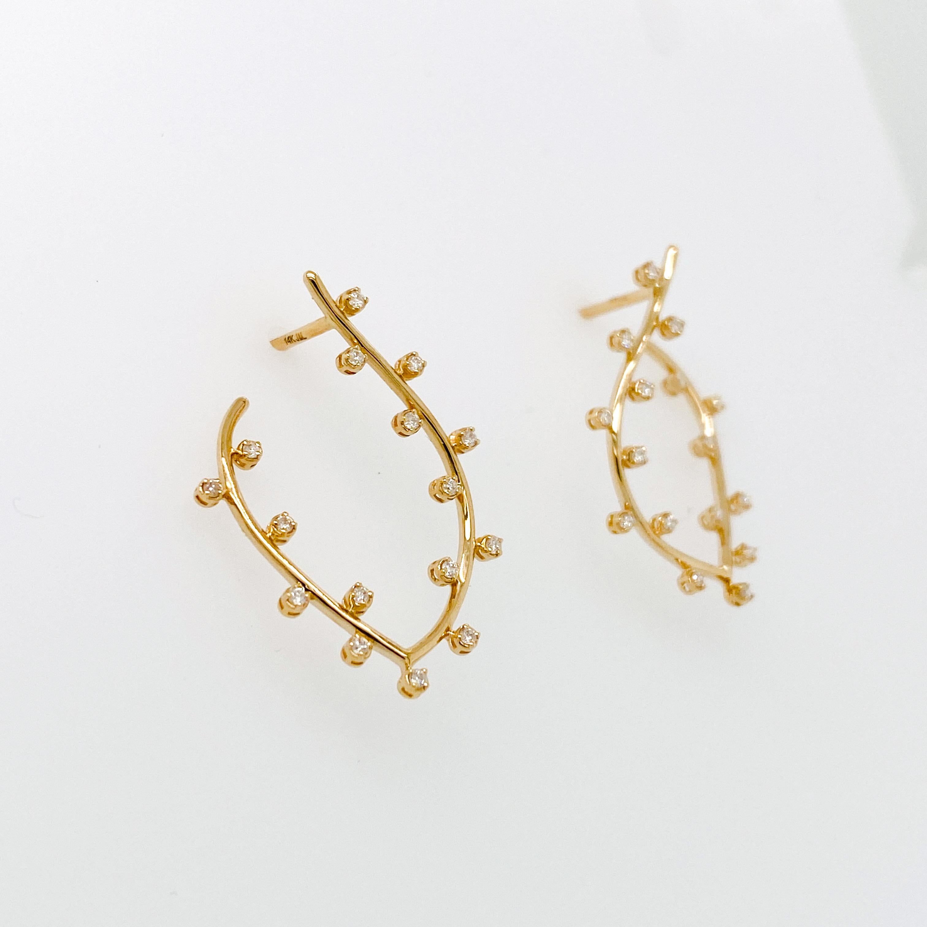 A creative arrangement of 14K gold leaf vine shape with 32 diamonds. The diamonds are amazing quality and made to perfection. The earrings start in the front of your ear and end at the back of the ear. Each diamond is set in a secure 4 prong