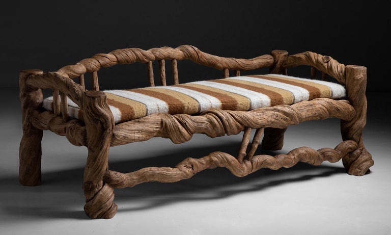 Vine wood bench with stripe wool seat cushion

Asia, circa 1980

Constructed from massive Liana Vines. Newly upholstered cushion.

75.25”L x 36”D x 25.5”H x 21.25”seat.