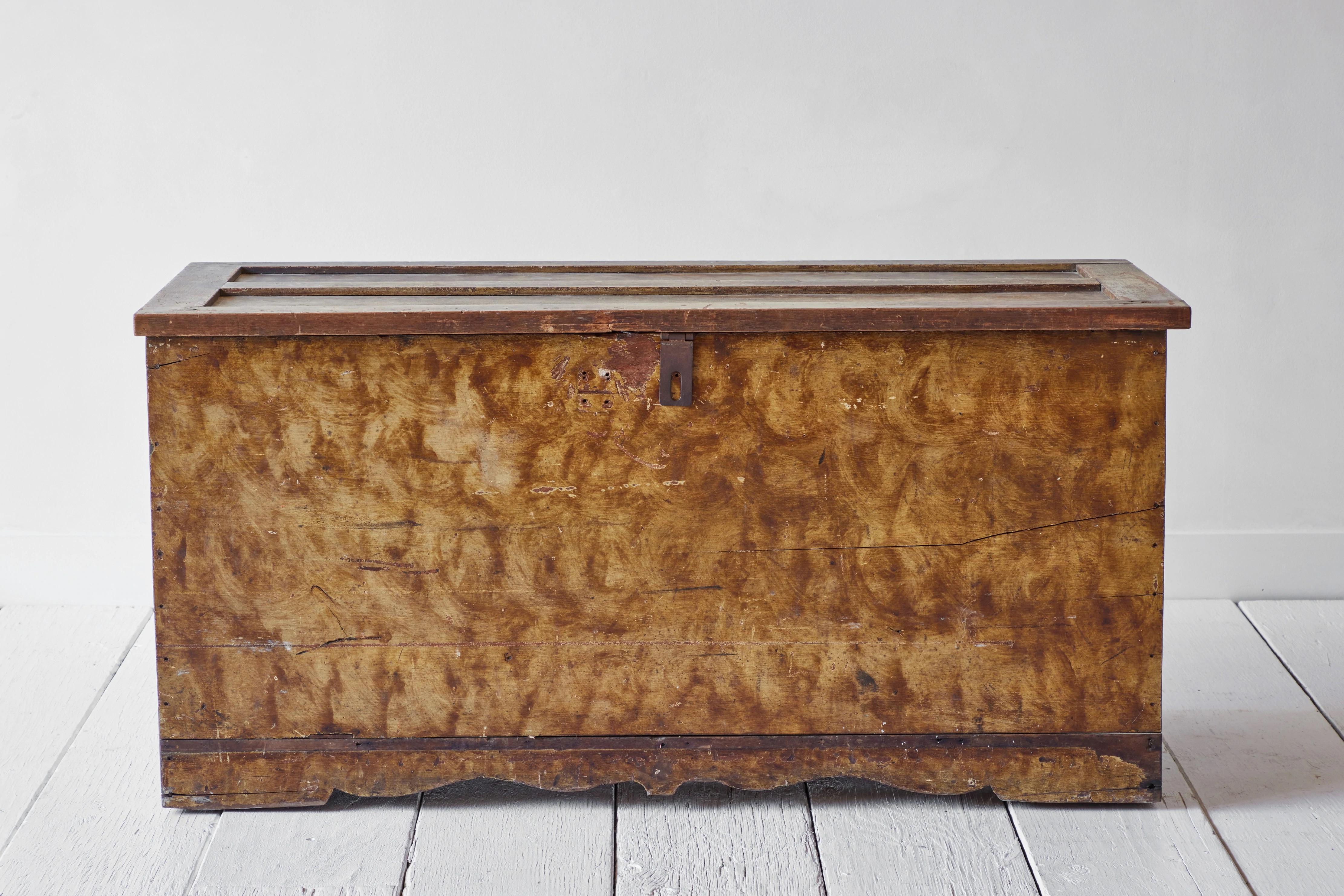 Early American blanket chest with vinegar grain paint finish. 
 