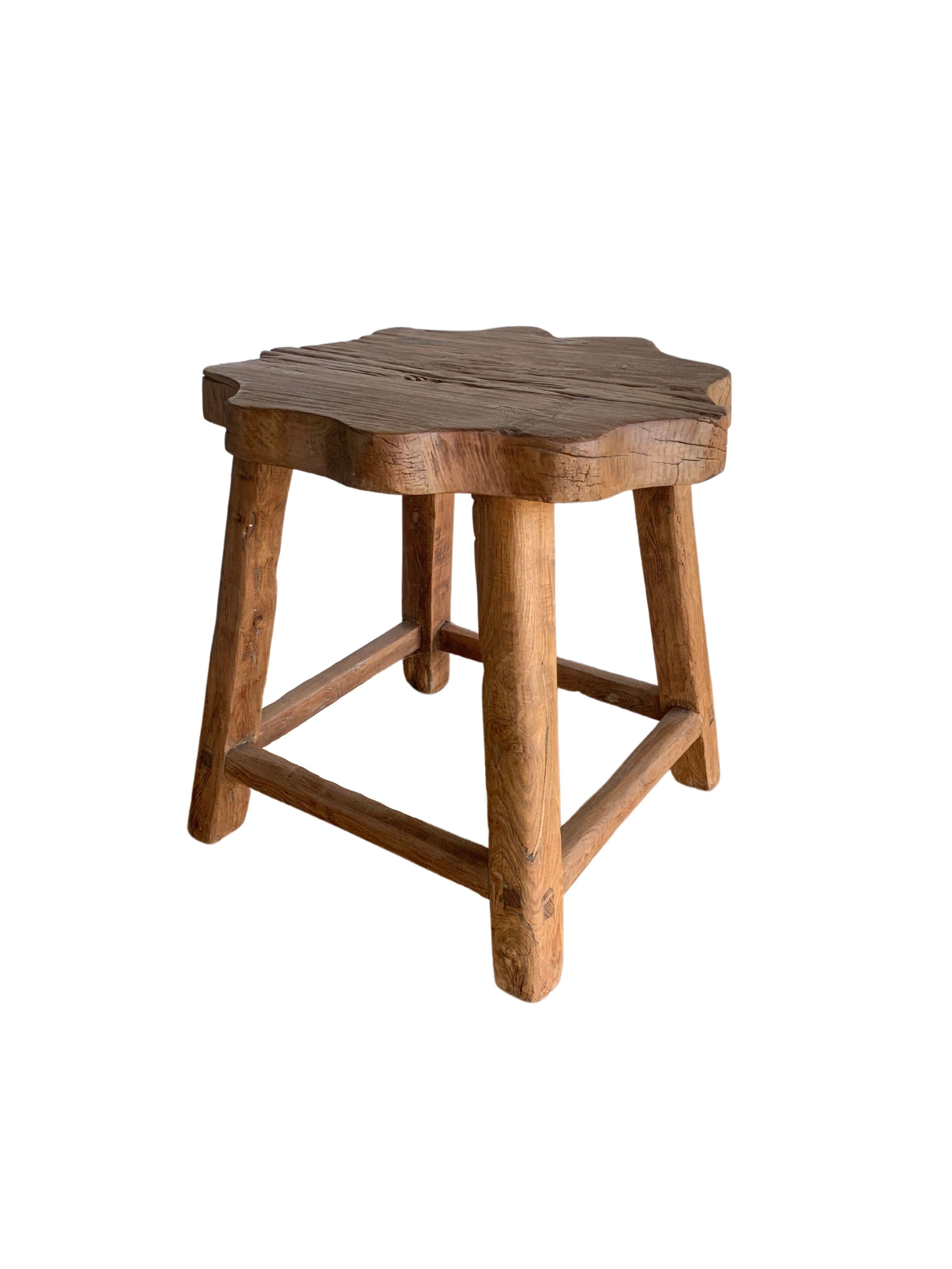This elm wood stool comes from China's Hubei province. It was crafted using only wooden joints. The elm wood has a wonderful wood texture. A spacious seat with a floral shape and angular legs add to its charm.

Dimensions: Height 56cm x diameter