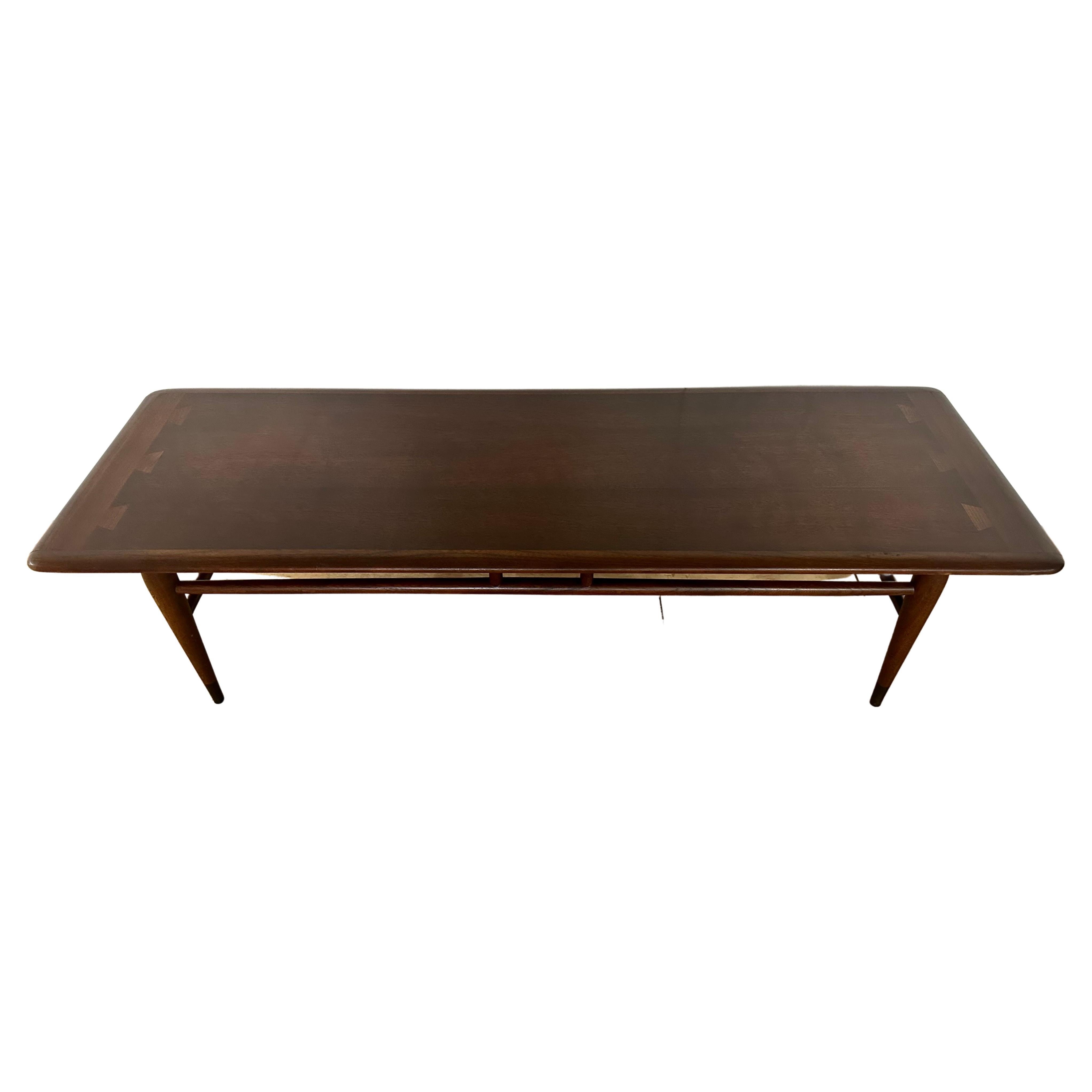 This walnut coffee table balances stylish warmth of Scandinavian Modern chic and the clean curves that gives the tabletop a streamlined appearance with tapered legs that creates a graceful poise.